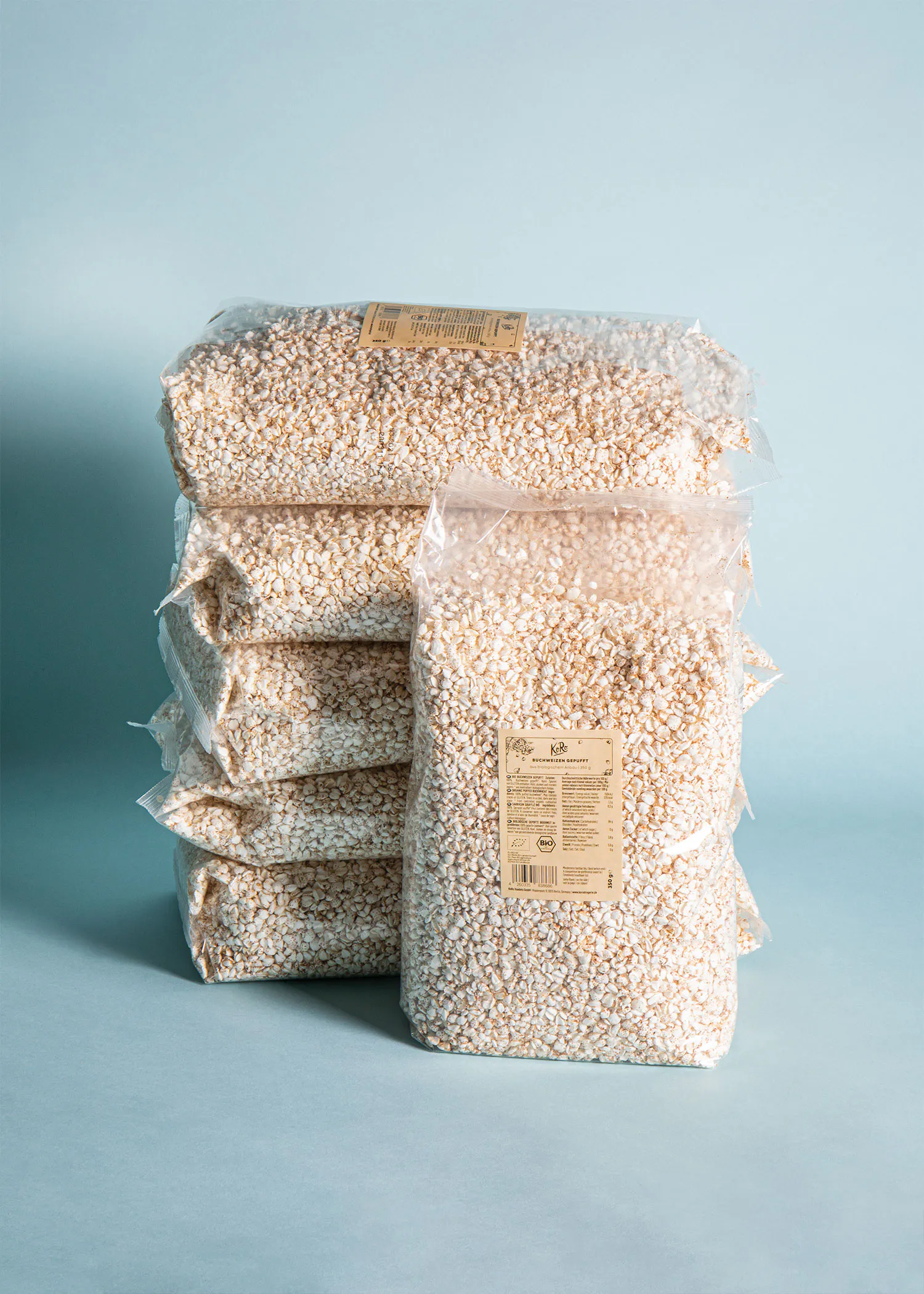 bags of popcorn are stacked on top of each other on a blue surface