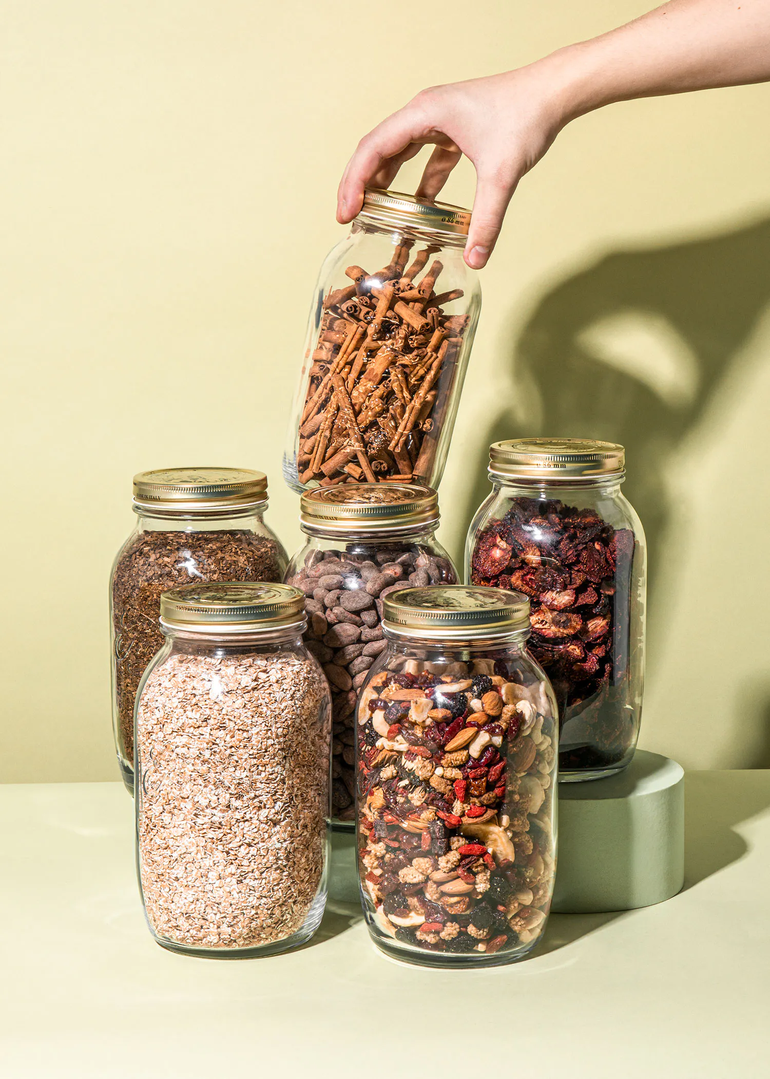 a hand reaches into a jar of pretzels