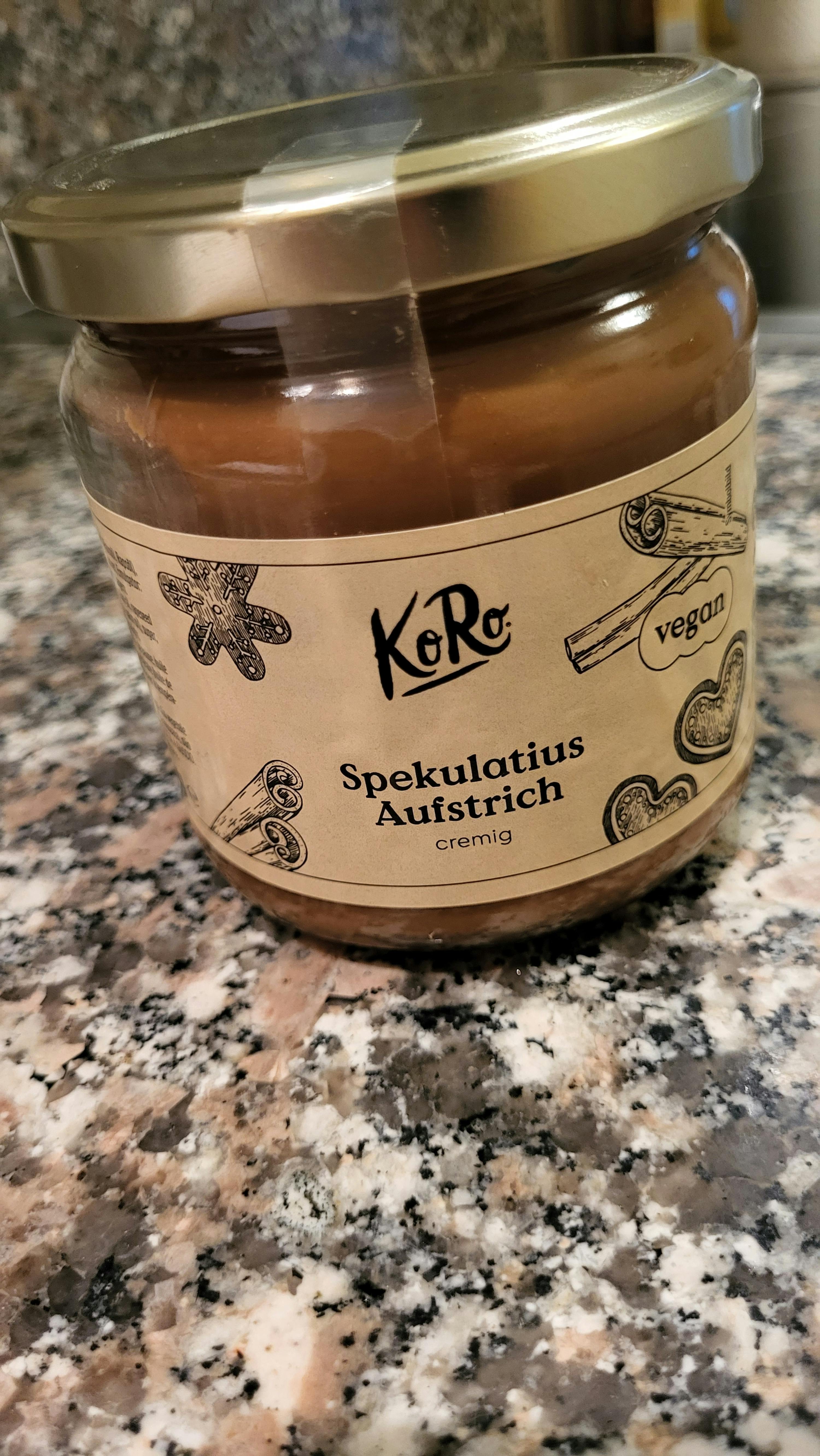 a jar of spelulatius austrich cream sits on a granite counter