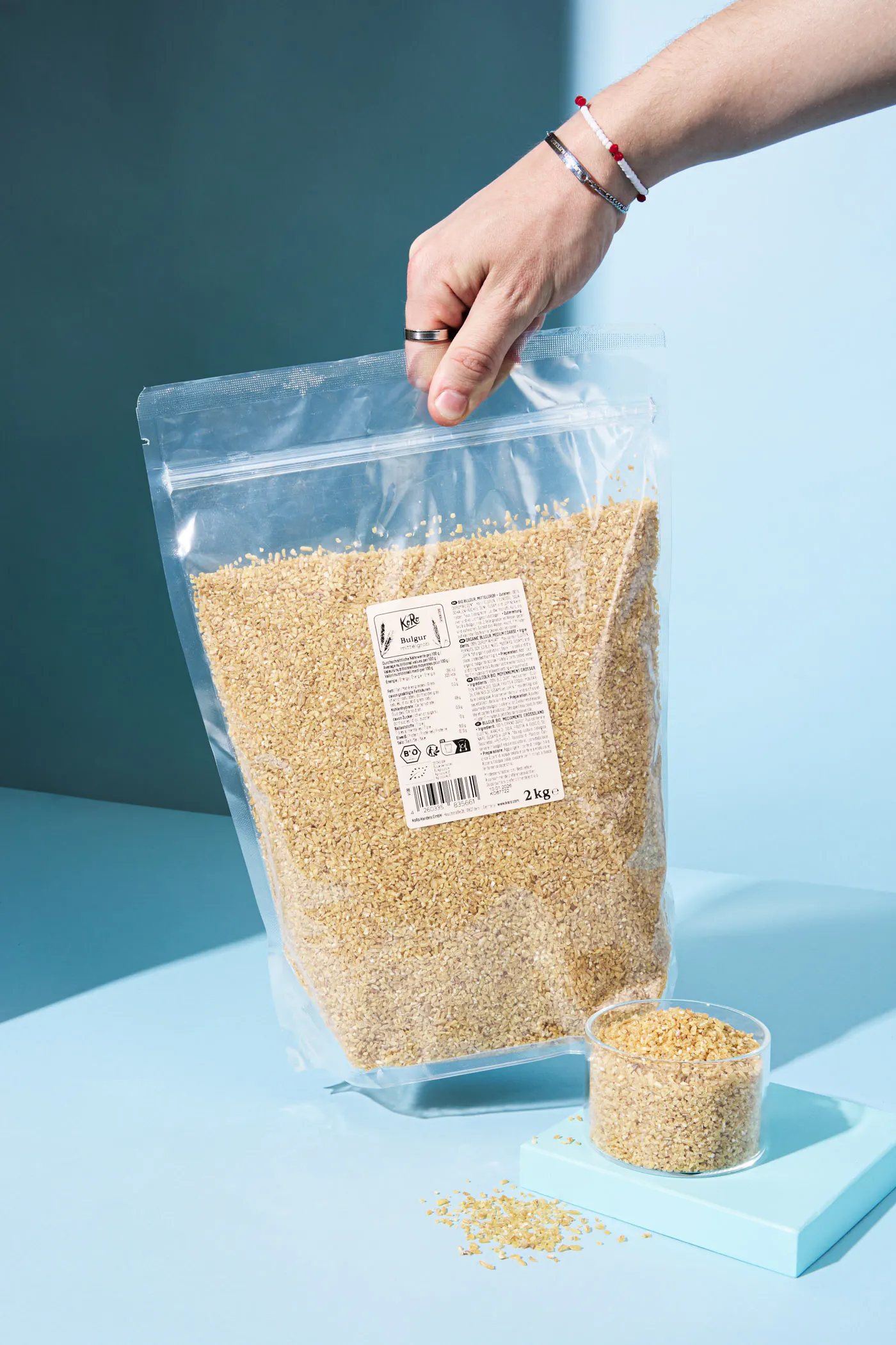 a person is holding a bag of sesame seeds with a label on it