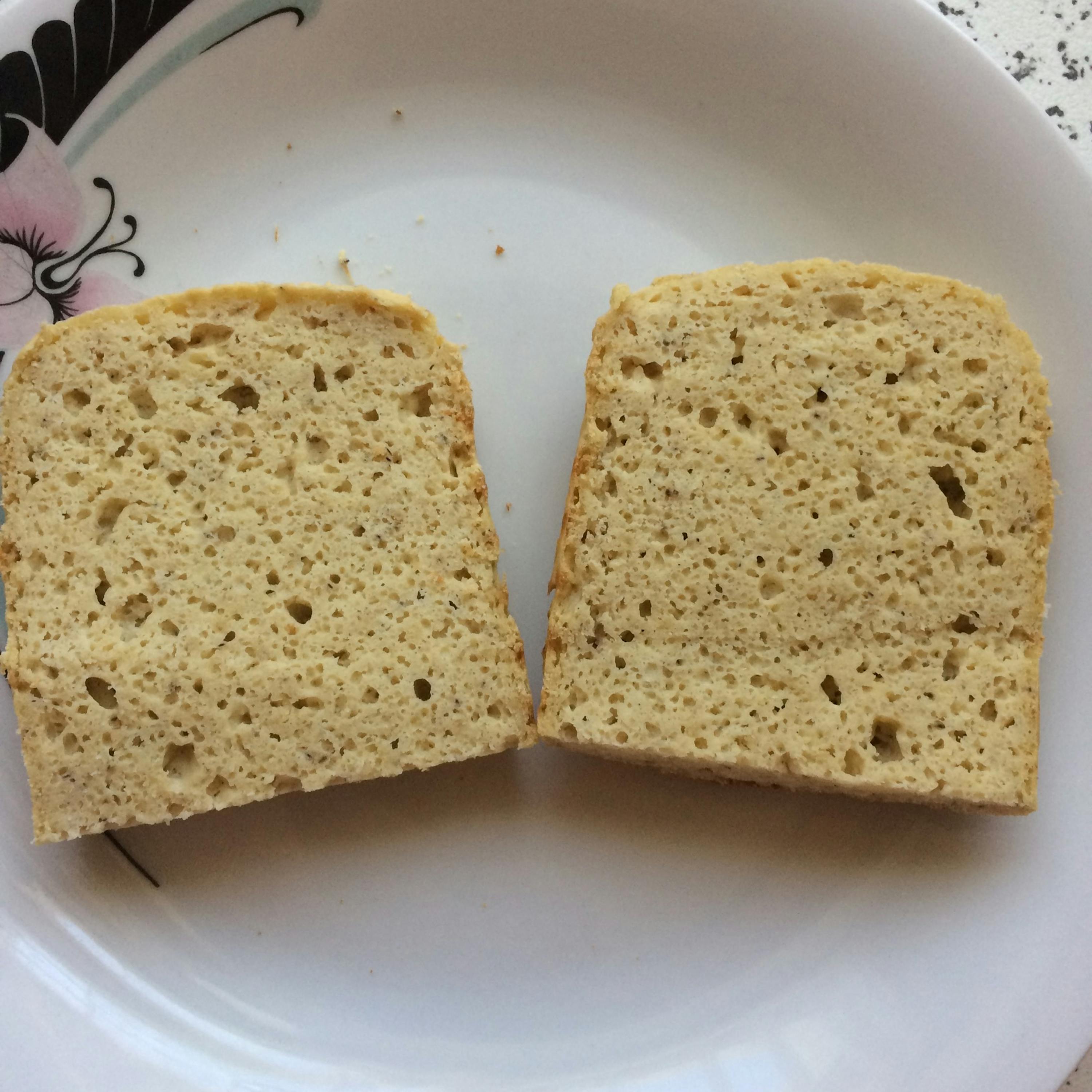 two slices of bread on a white plate with a butterfly design