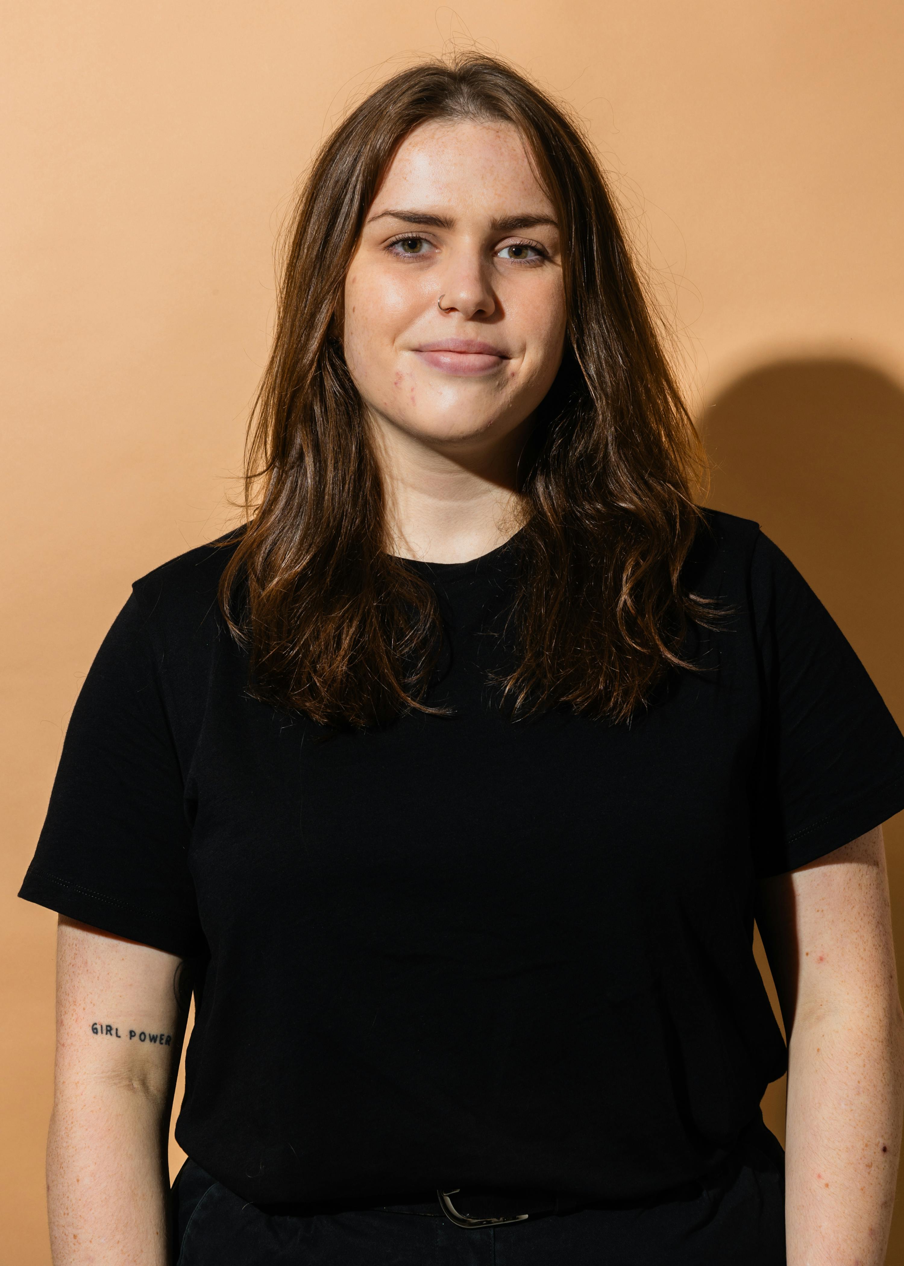 a woman has a tattoo on her arm that says girl power