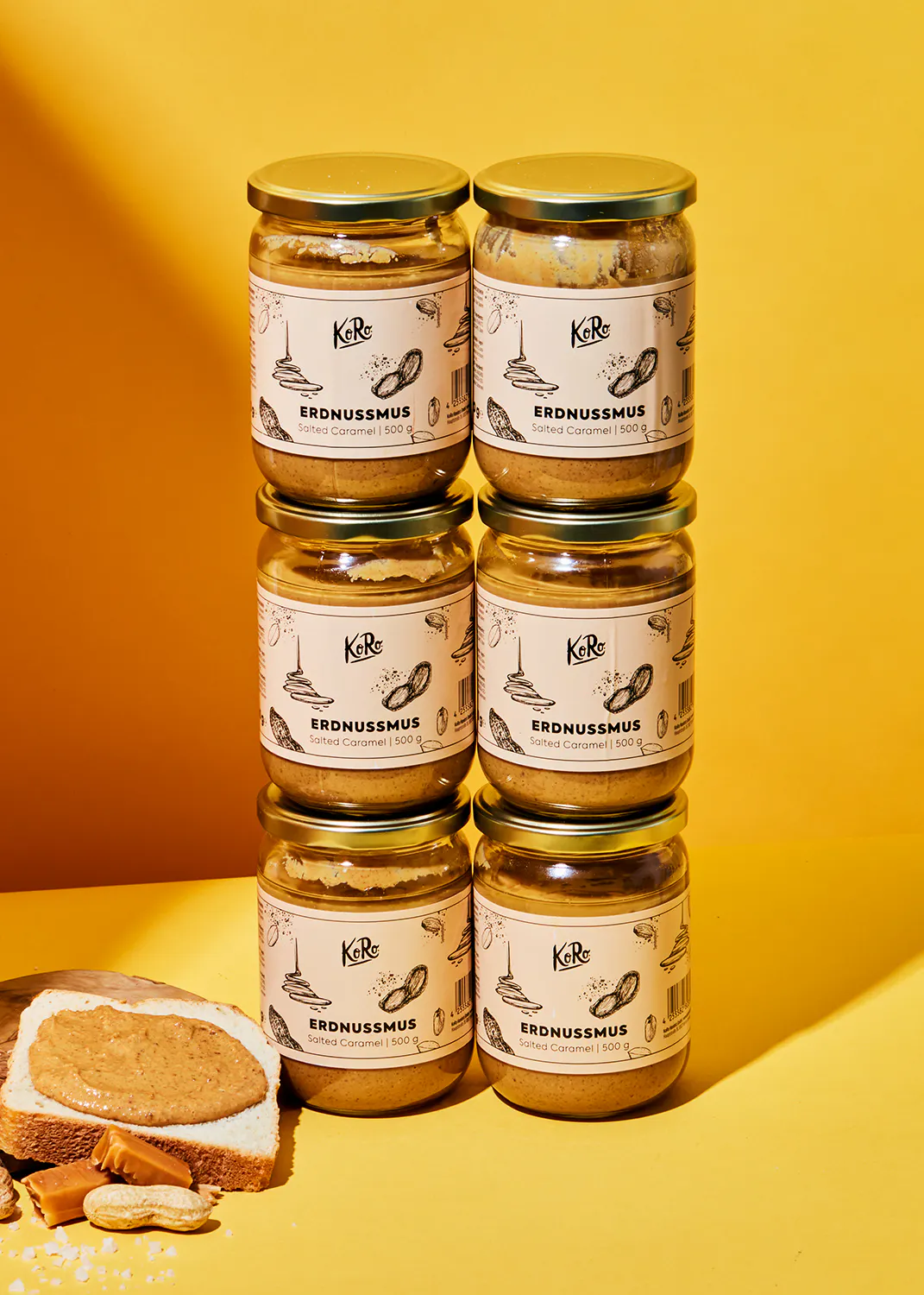 four jars of erdnussmus are stacked on top of each other
