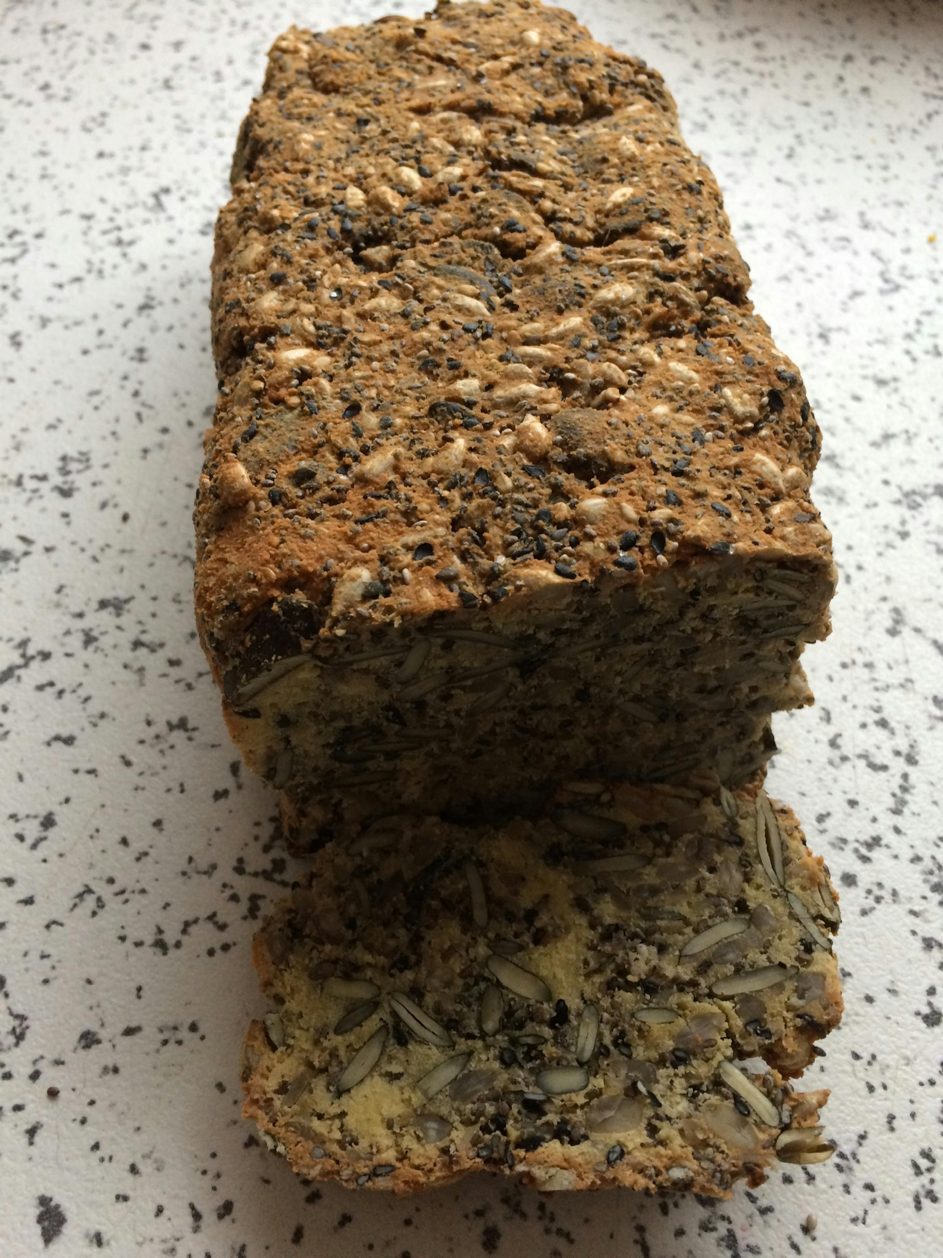 a loaf of bread with seeds on it is sitting on a counter