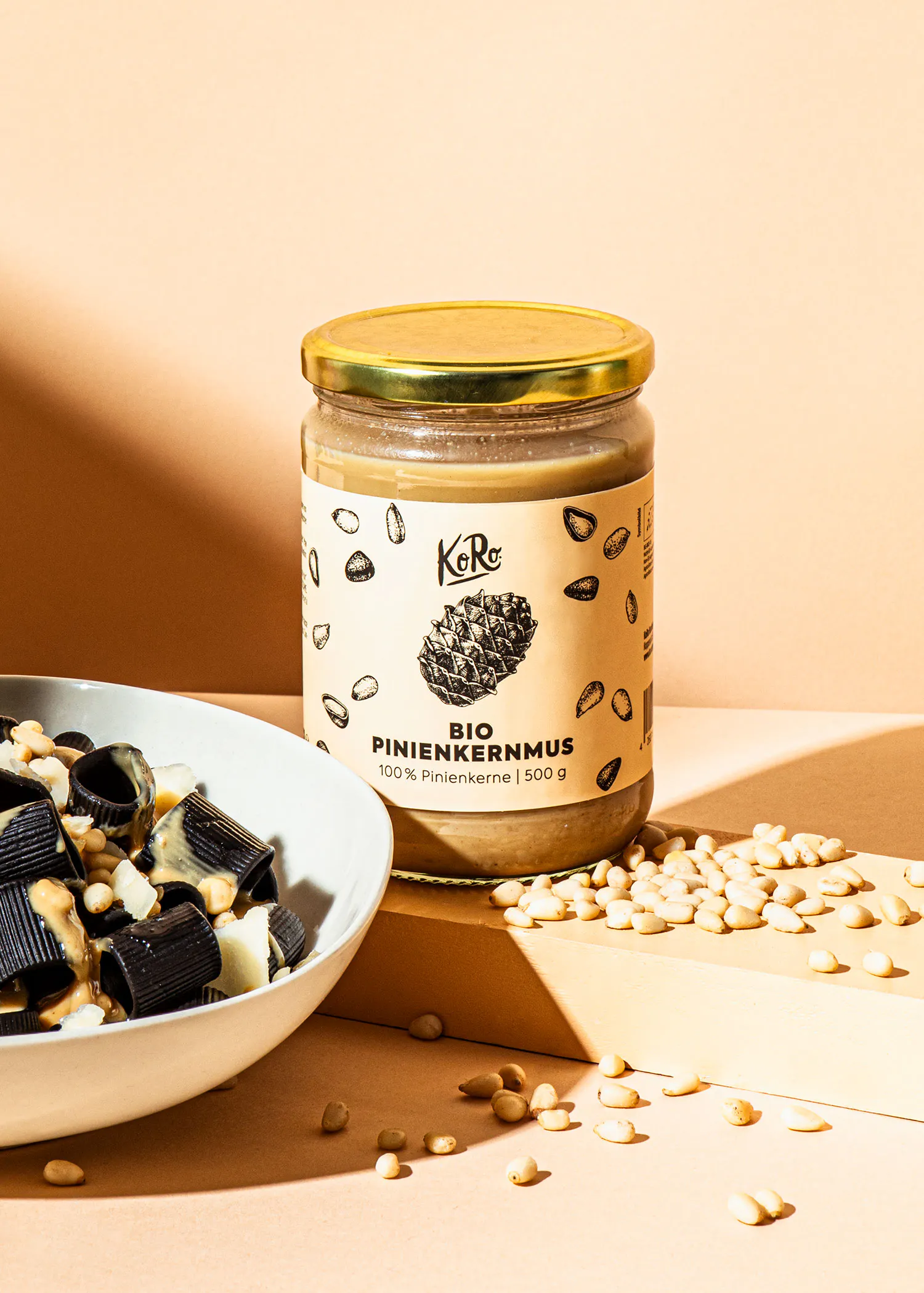 a jar of bio pinienkernmus next to a bowl of chocolate