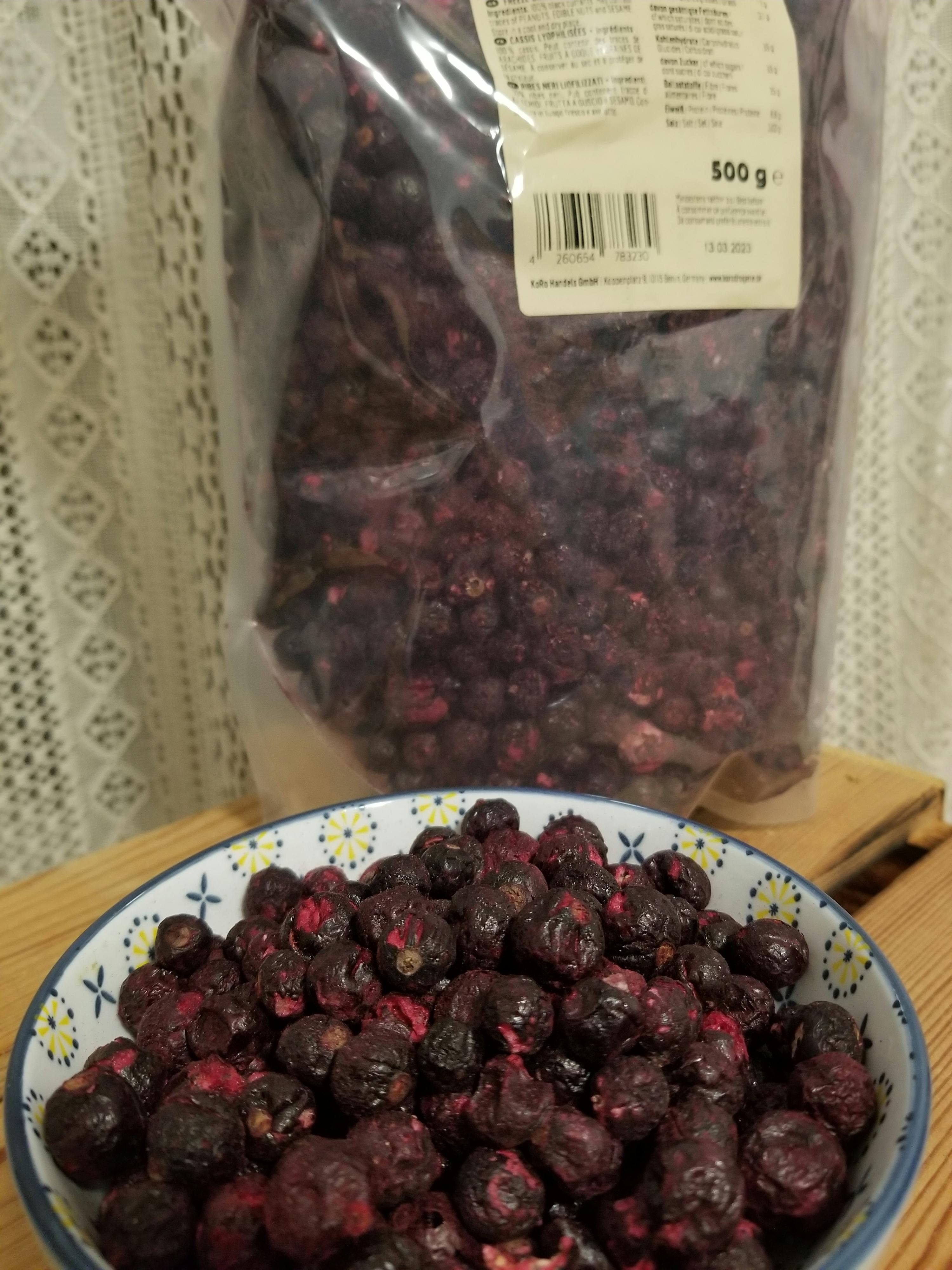 a bag of blueberries next to a bowl of blueberries