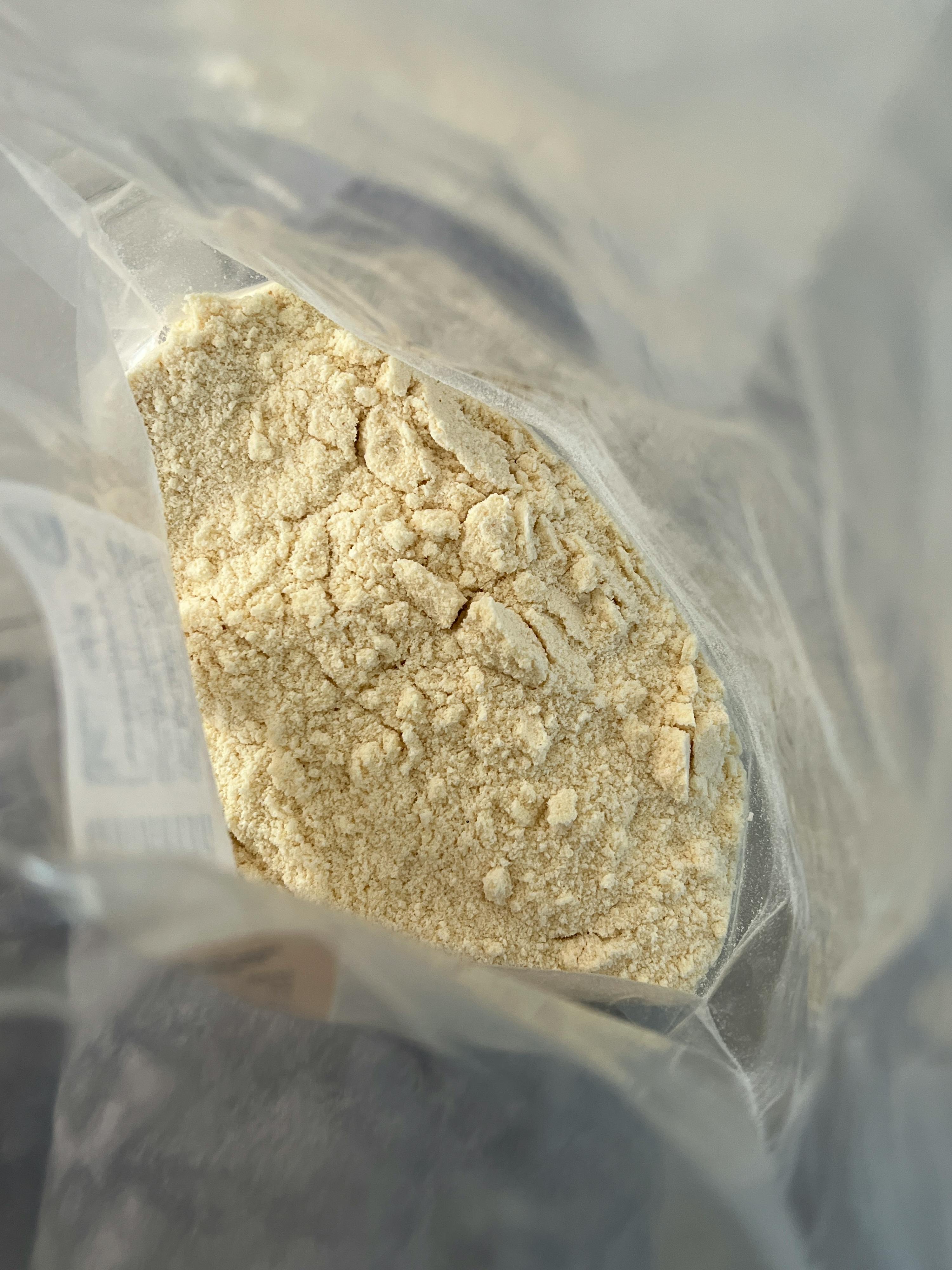 a plastic bag filled with white powder has a white label on it