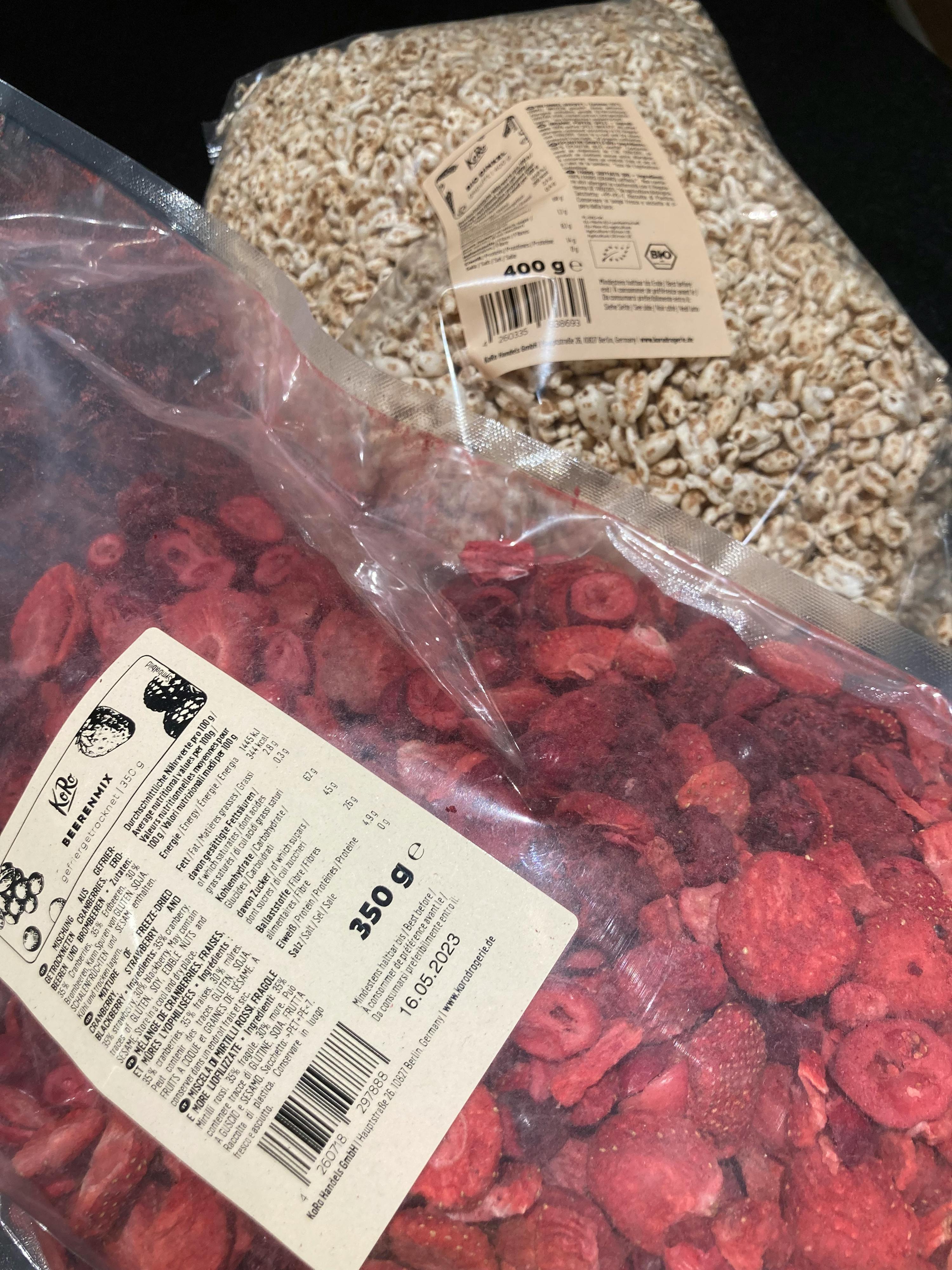 a bag of strawberries next to a bag of oats