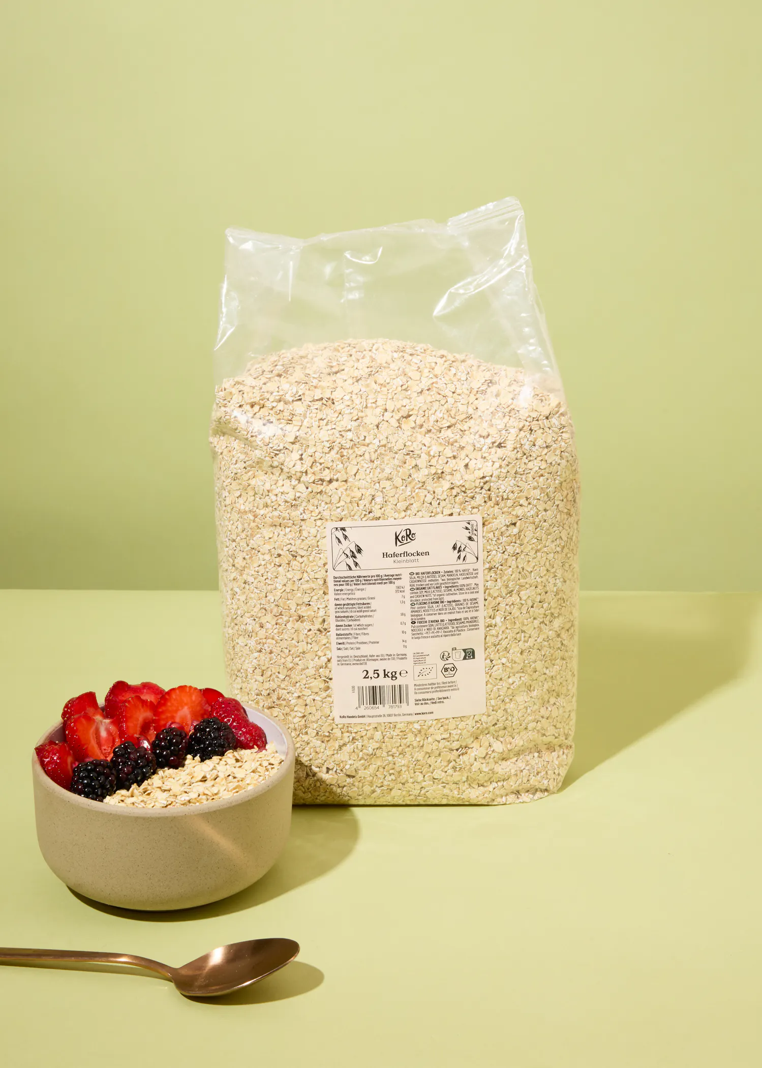 un sac de flocons d' avoine est assis à côté d' un bol de flocons d' avoine
