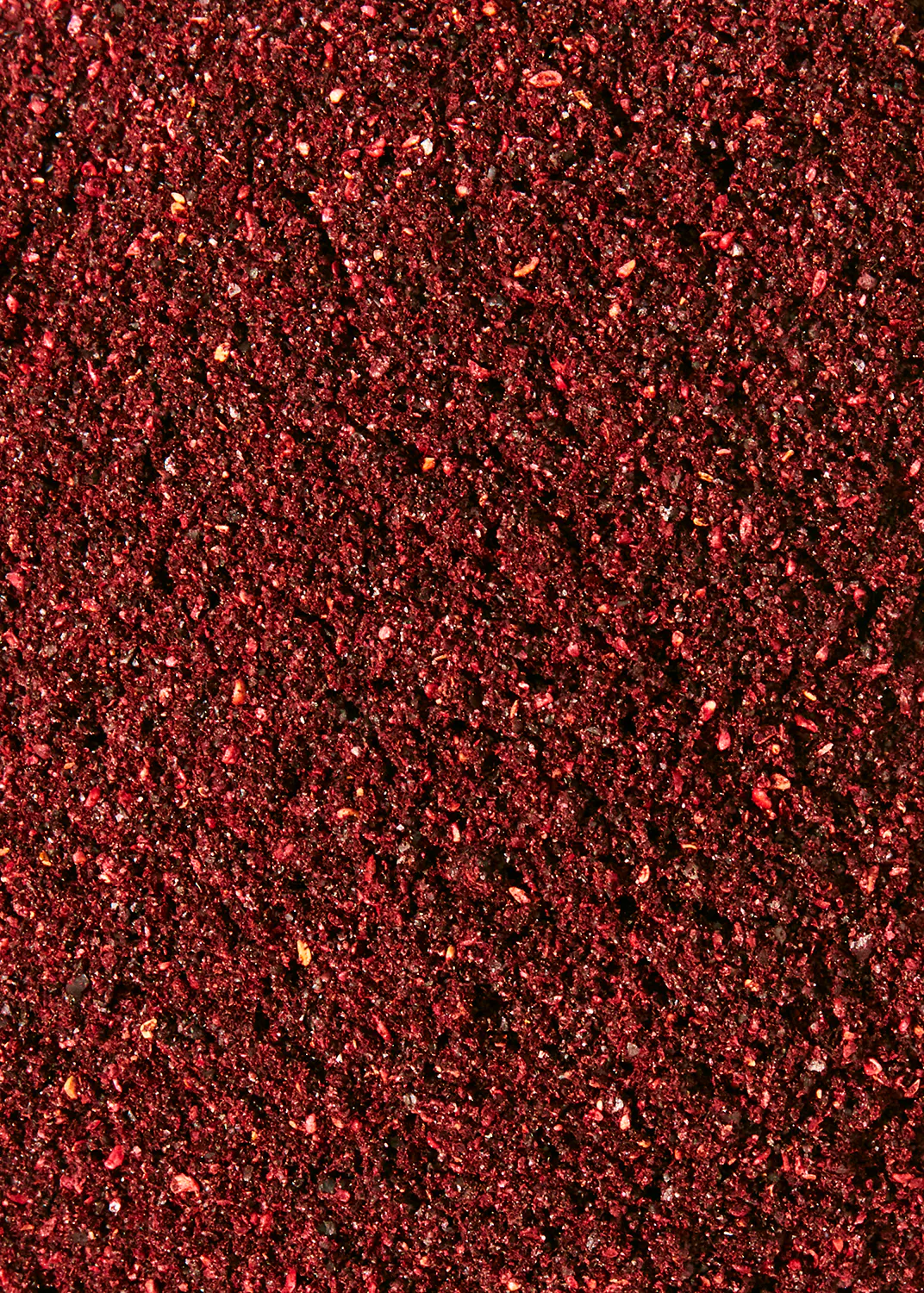 a close up of a red colored surface with a black background