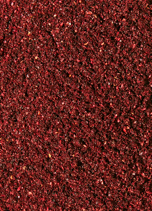 a close up of a red colored surface with a black background