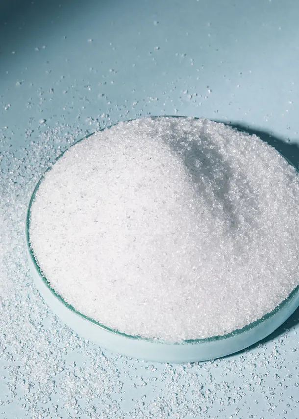 a glass bowl filled with white powder on a blue surface