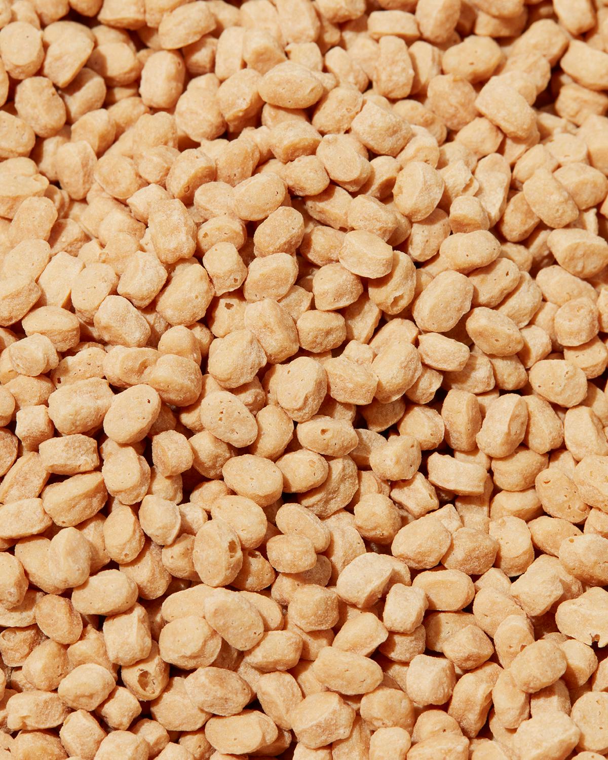 Pea 71% protein crispies 1kg a close up of a pile of nuts with a few missing