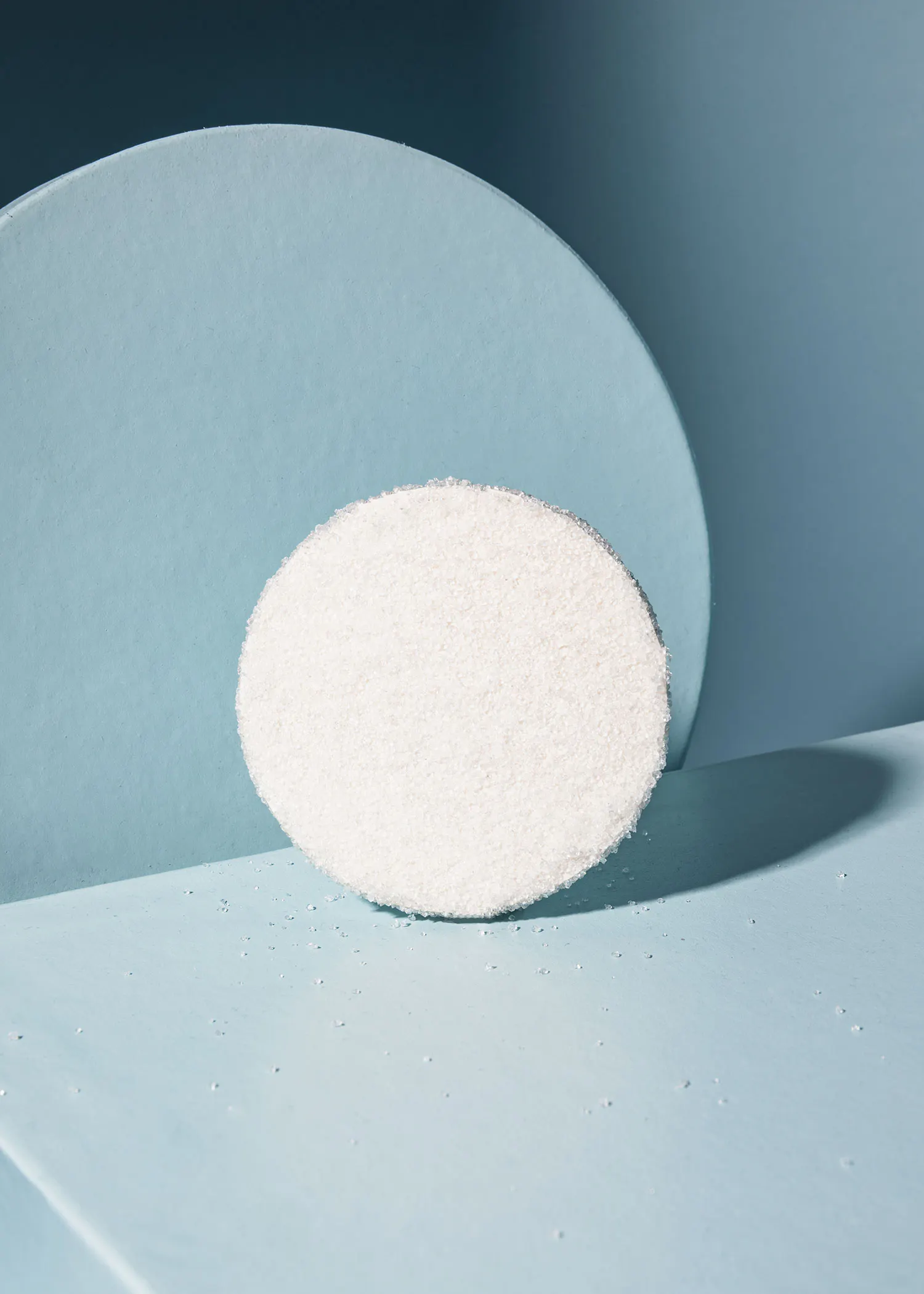 a white circle on a blue surface with a circle in the background