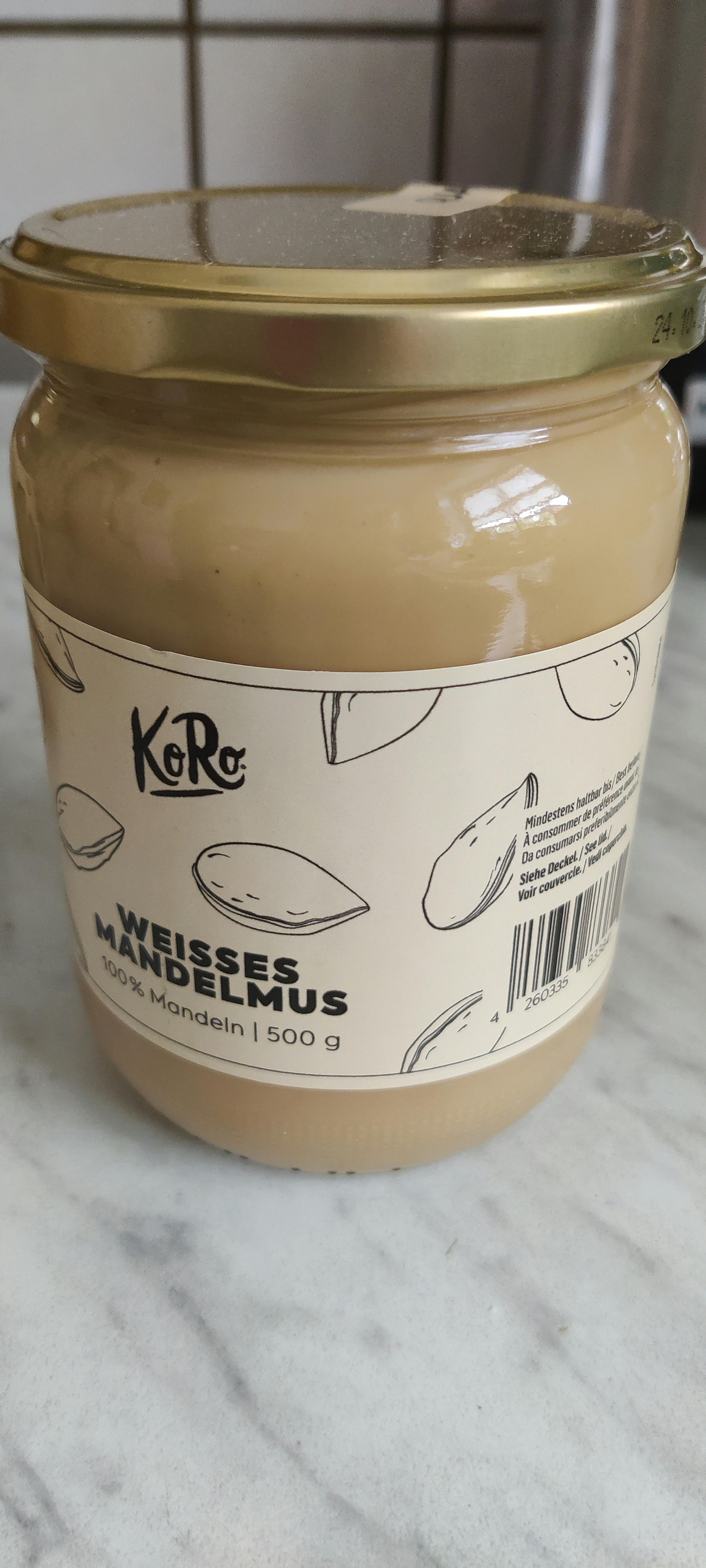 un barattolo di burro di mandorle è seduto su un tavolo di marmo