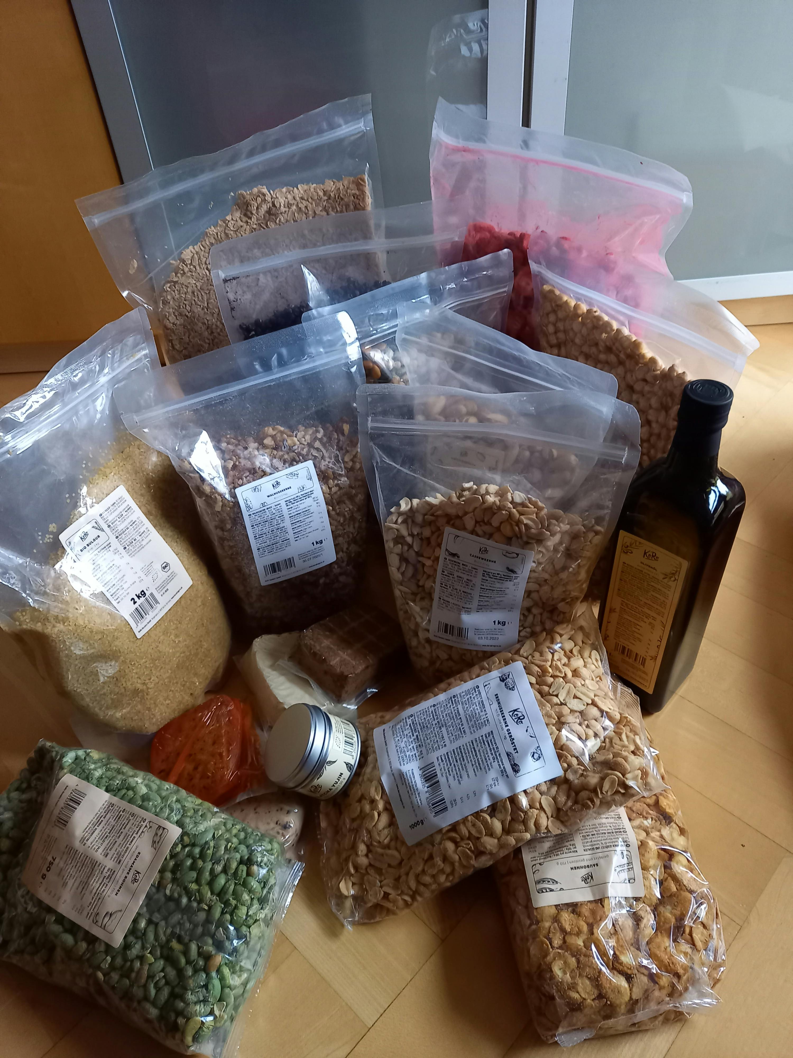 a bottle of extra virgin olive oil sits on top of a pile of food