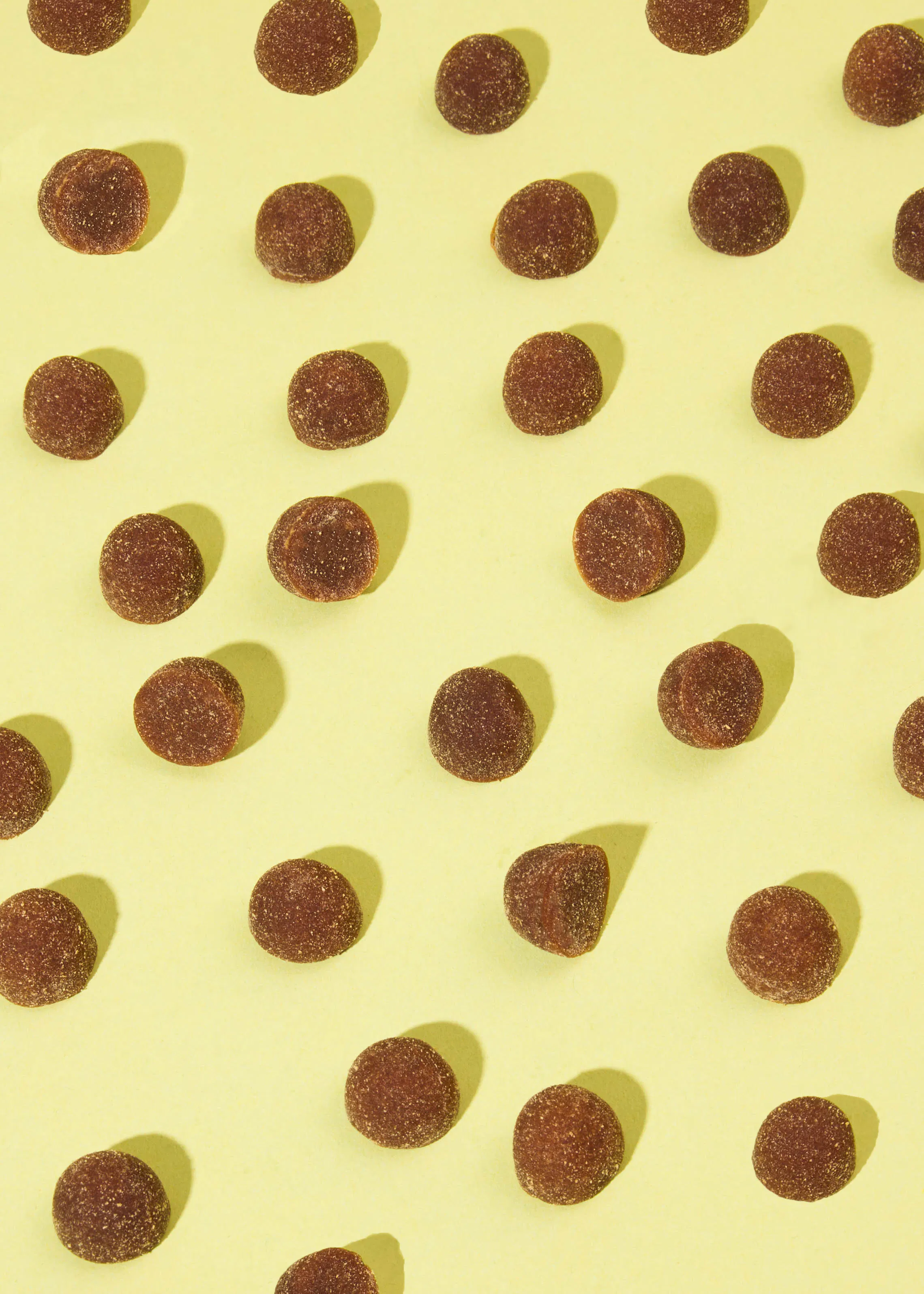 a yellow background with a pattern of brown circles