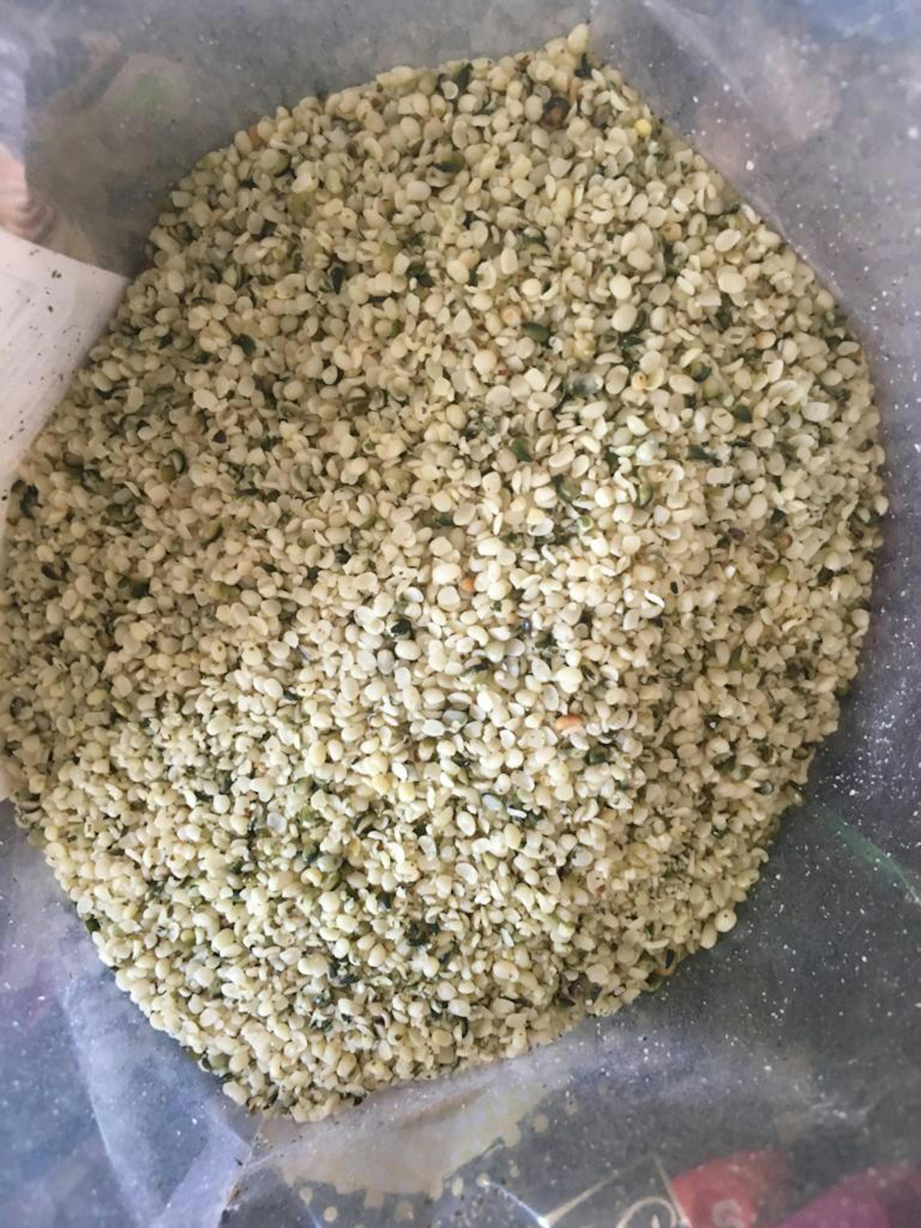 a bag of hemp seeds with green leaves
