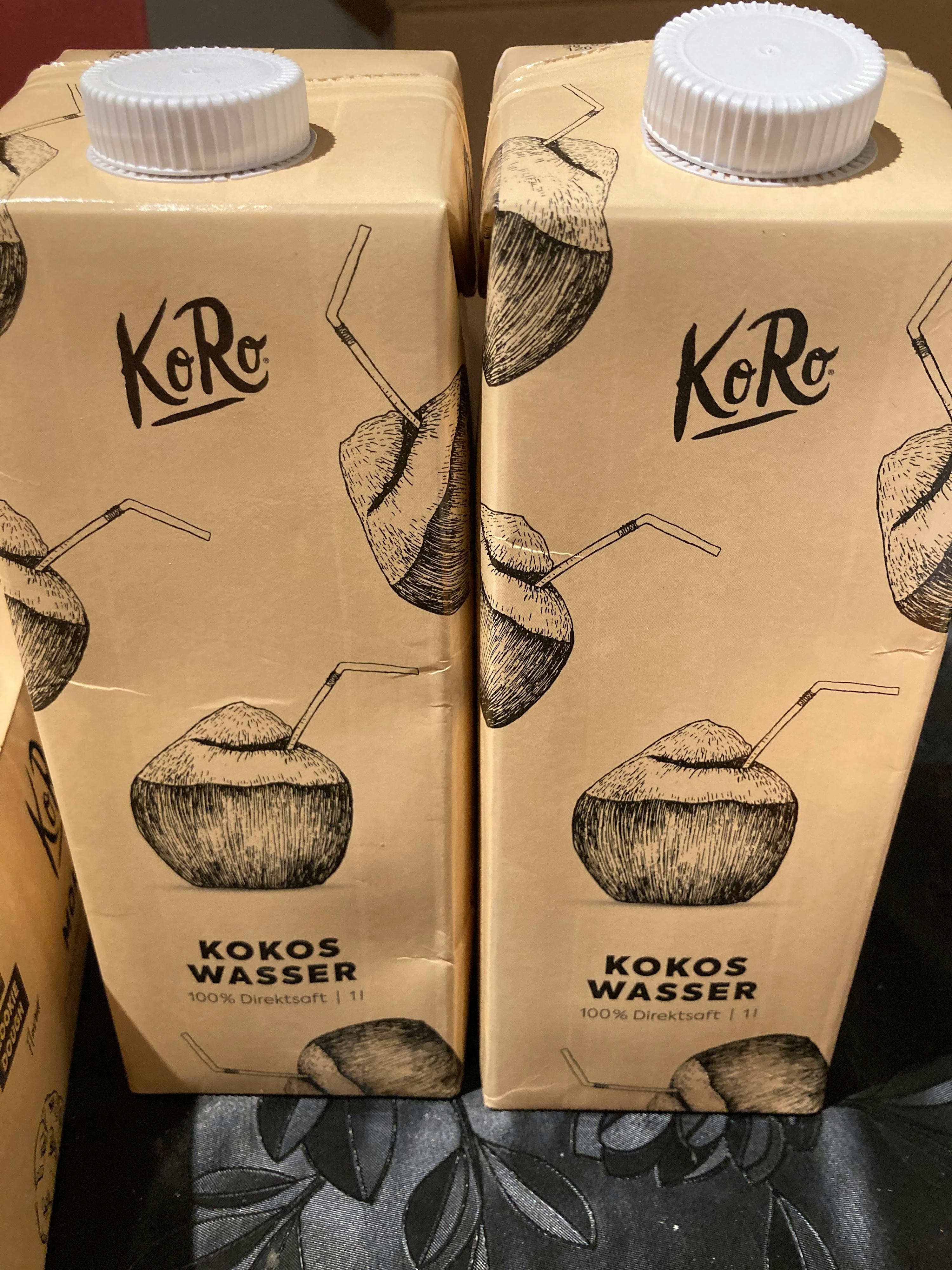 two cartons of koro kokos wasser are stacked on top of each other