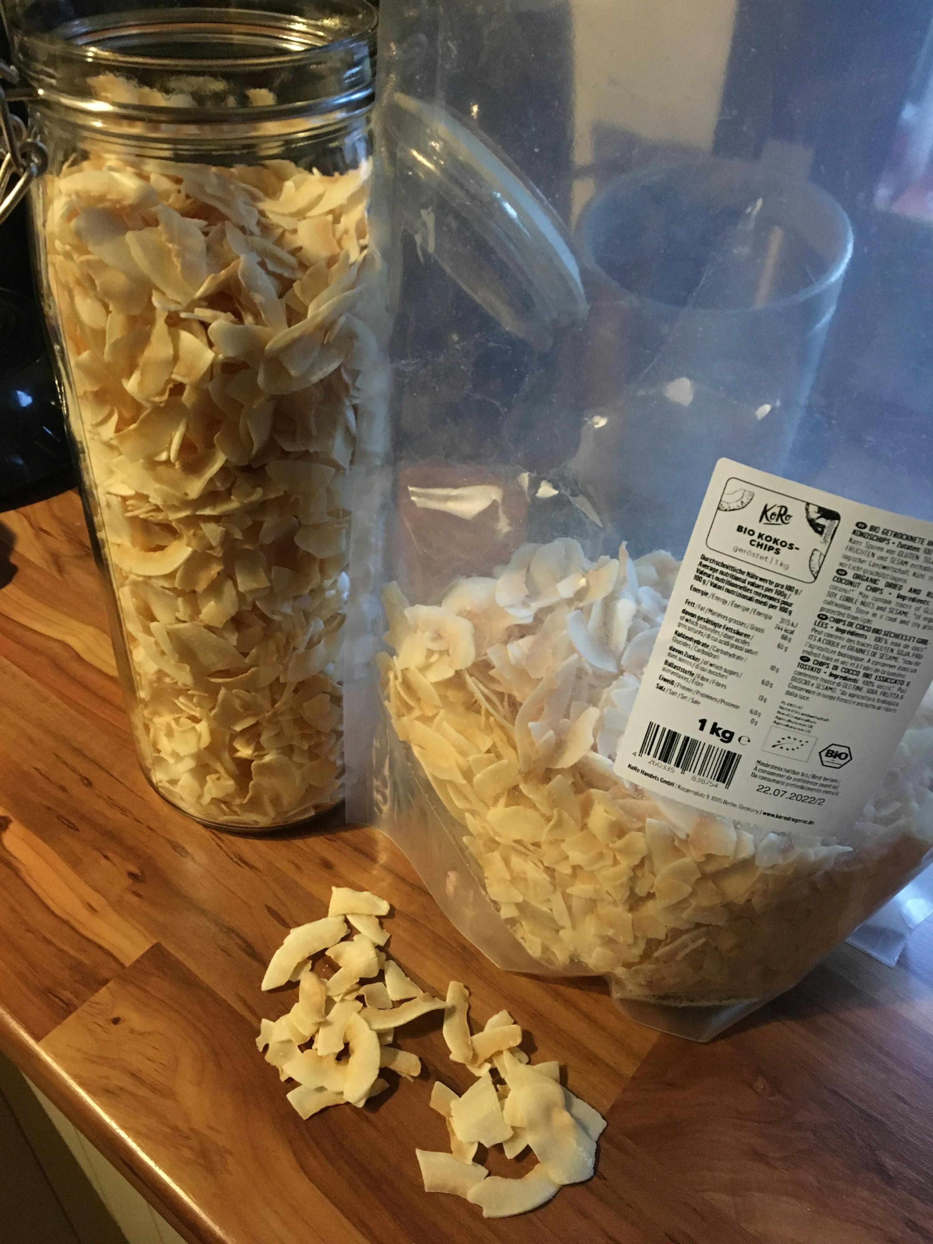 a bag of coconut chips sits next to a jar of coconut chips