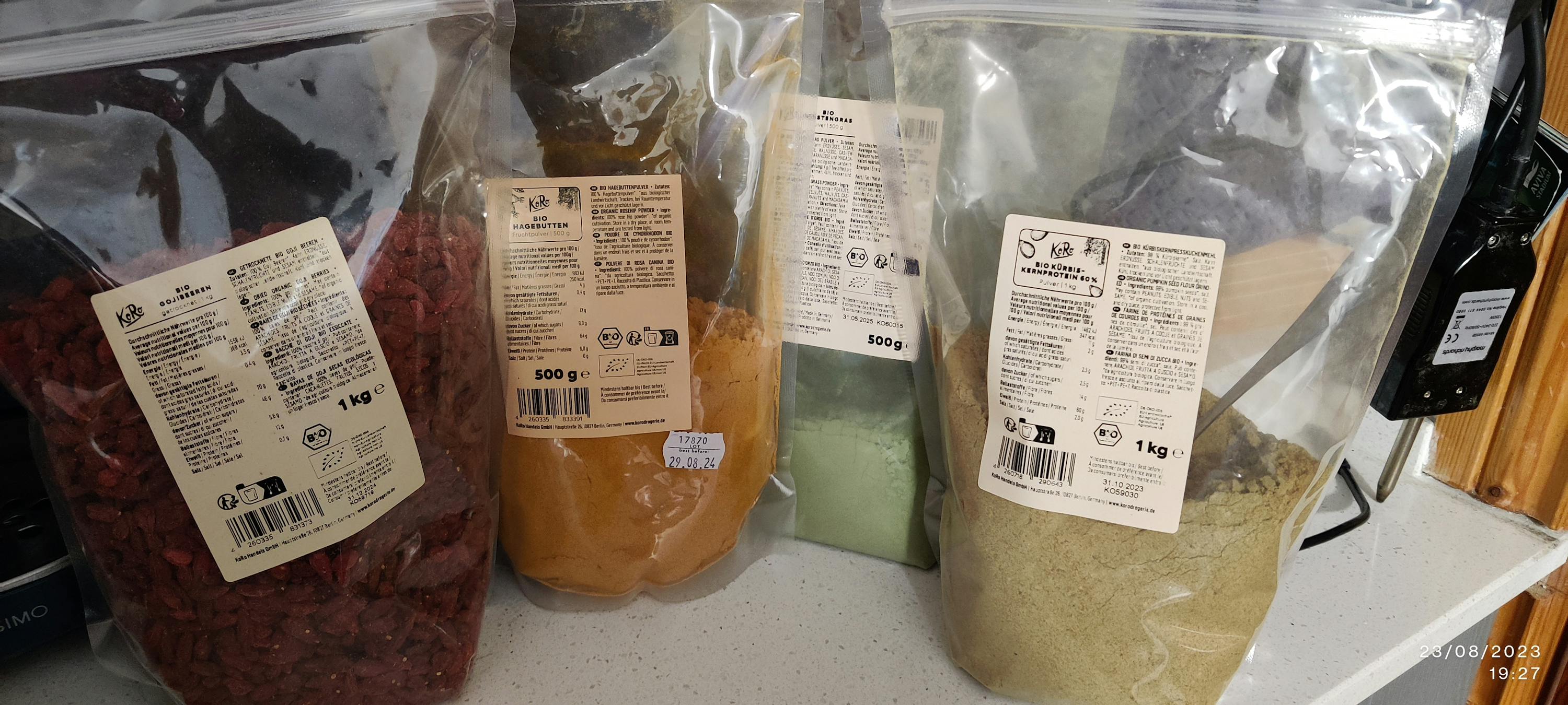 several bags of various powders are lined up on a counter