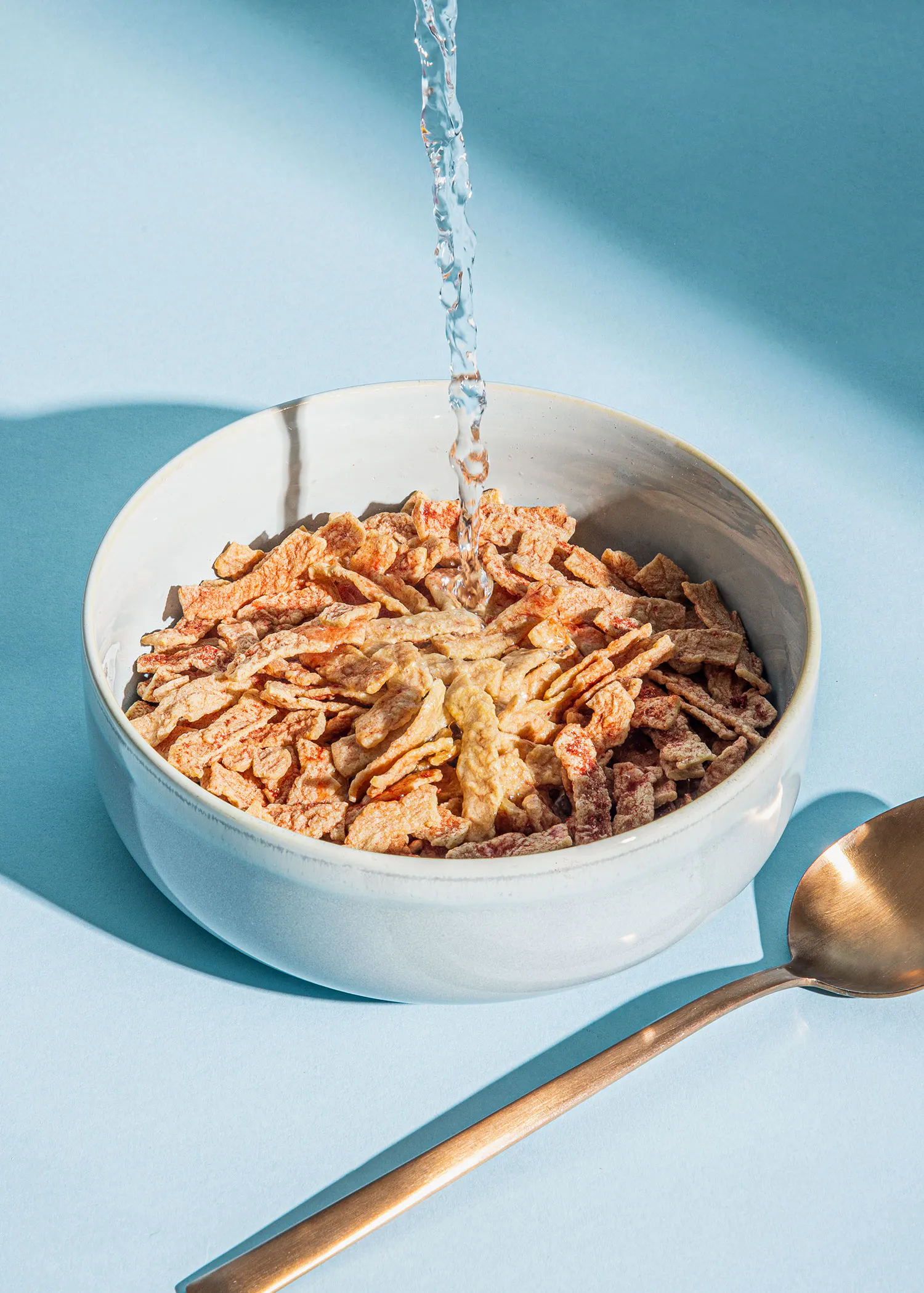 a bowl of cereal with water pouring into it