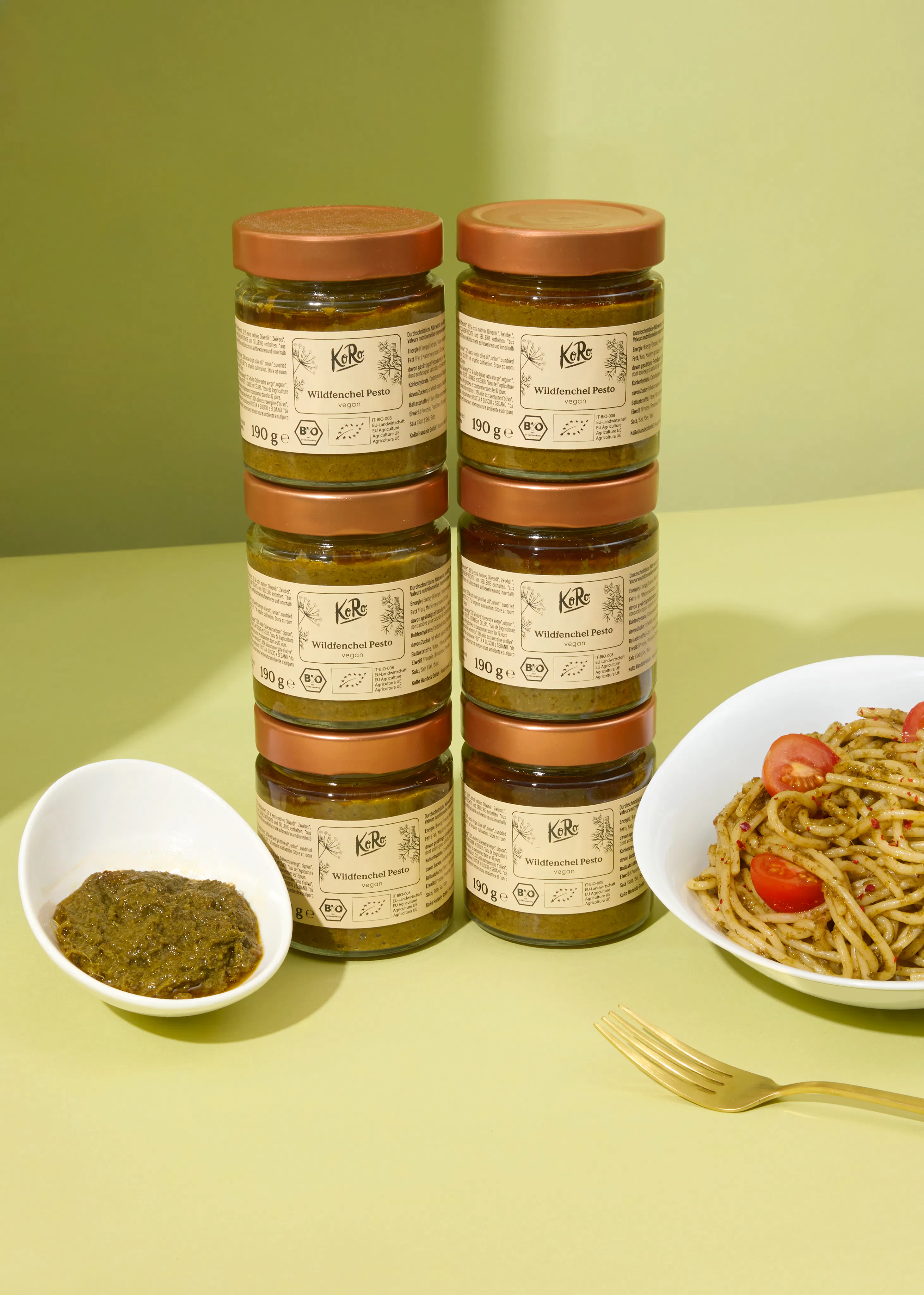 six jars of pesto are stacked on top of each other on a table