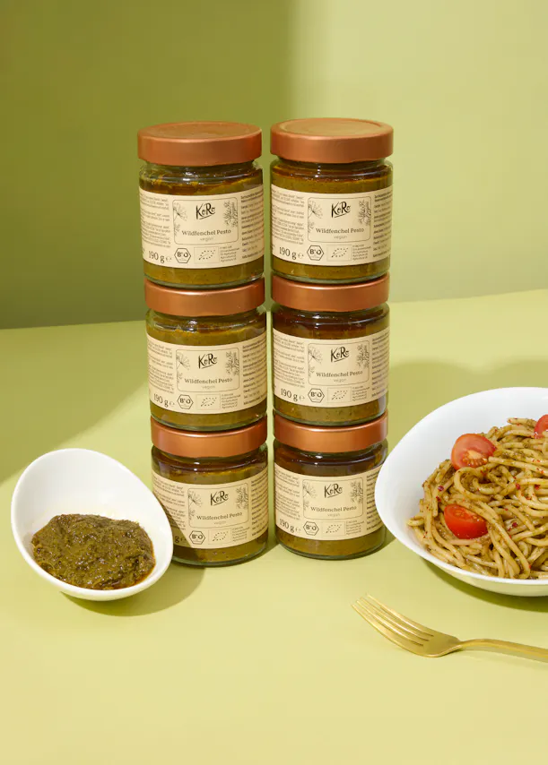 six jars of pesto are stacked on top of each other on a table