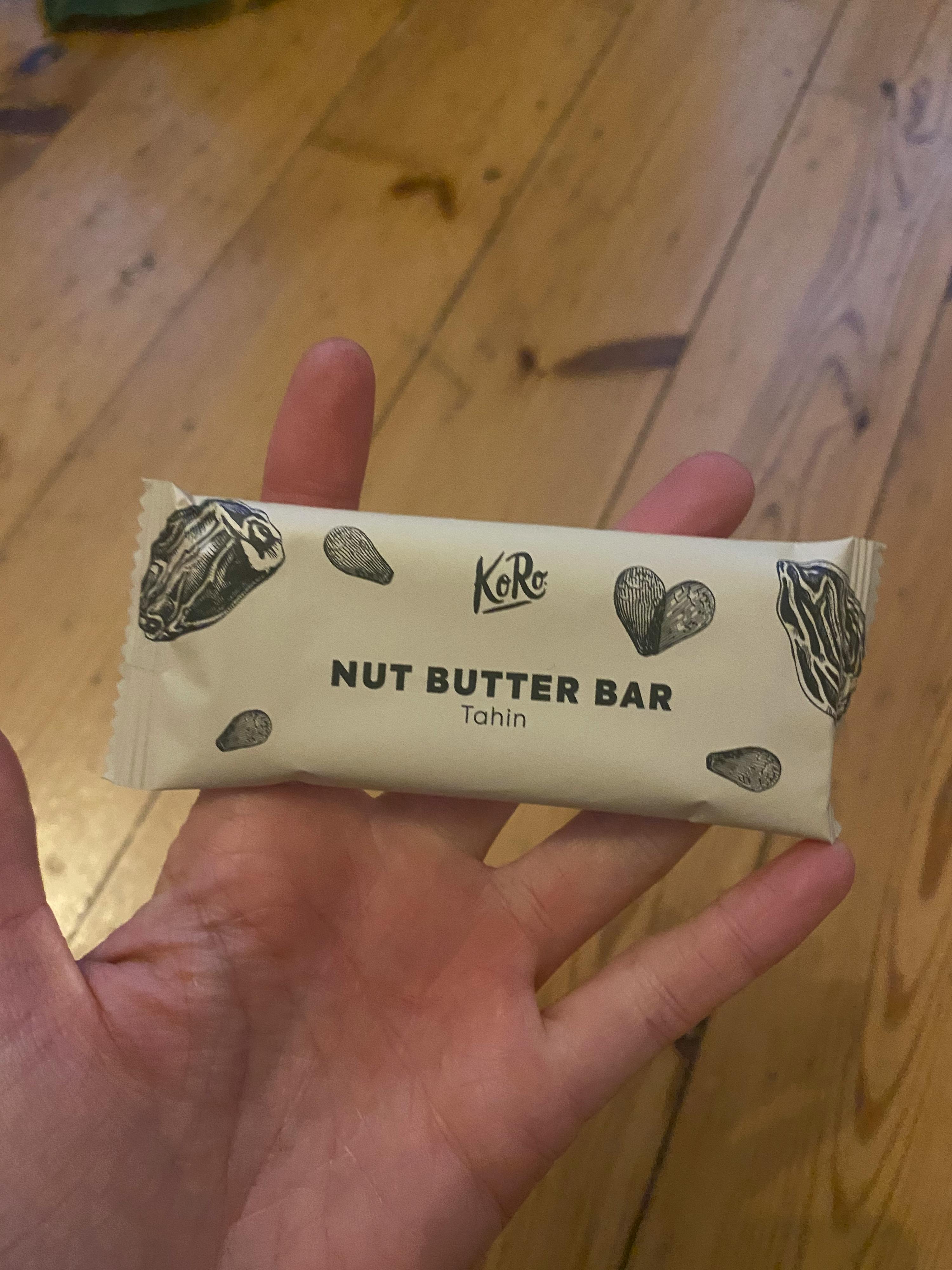 a person holding a nut butter bar in their hand