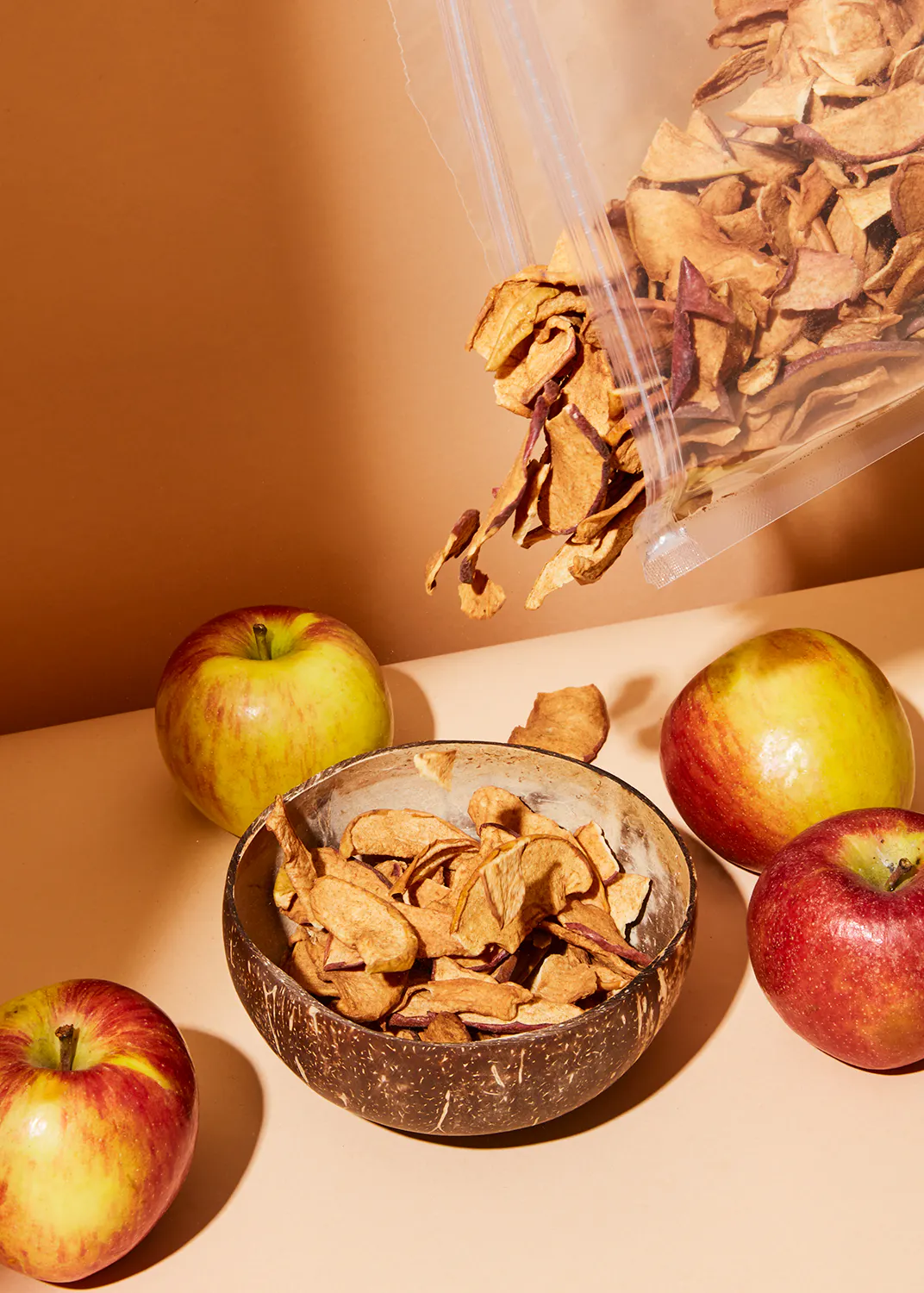 a bag of apple chips is being poured into a bowl