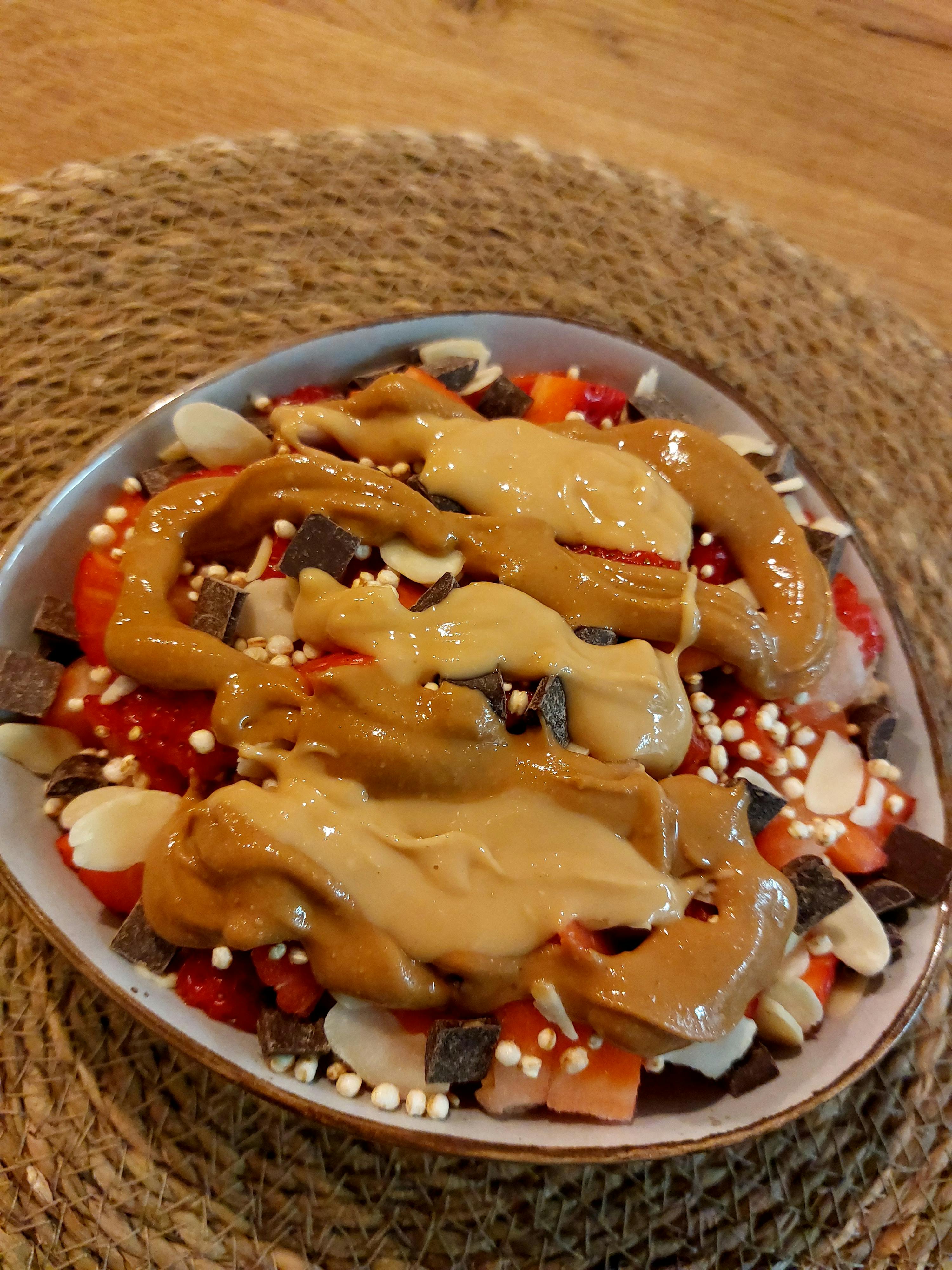 a bowl of food with peanut butter and chocolate chips on top