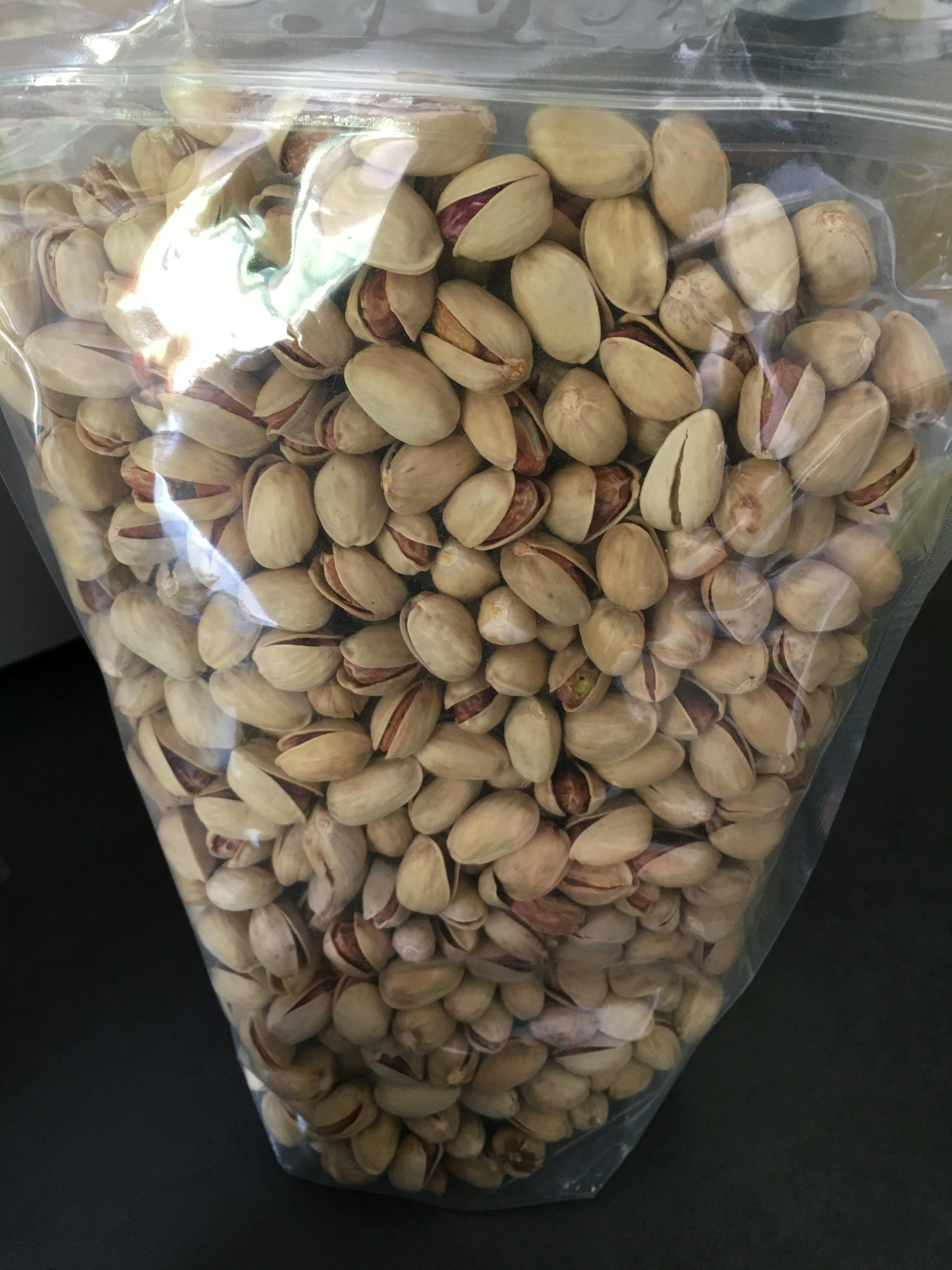a bag of pistachios in their shells is sitting on a table