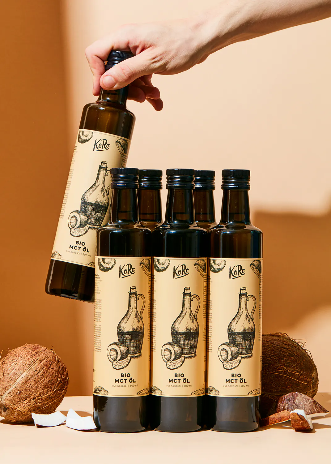 a person is pouring a bottle of bio mct oil