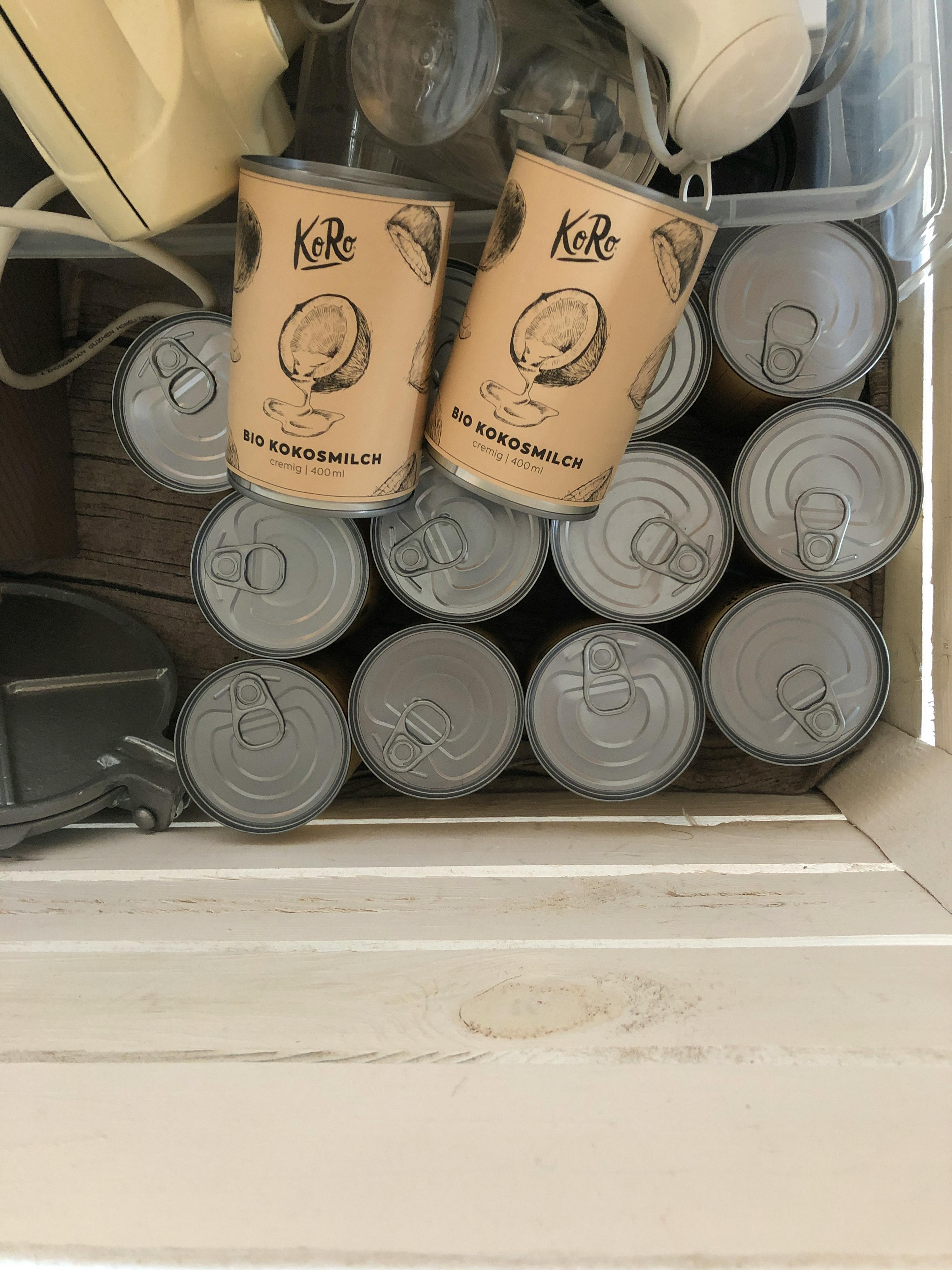 several cans of koko coconut milk are stacked on top of each other
