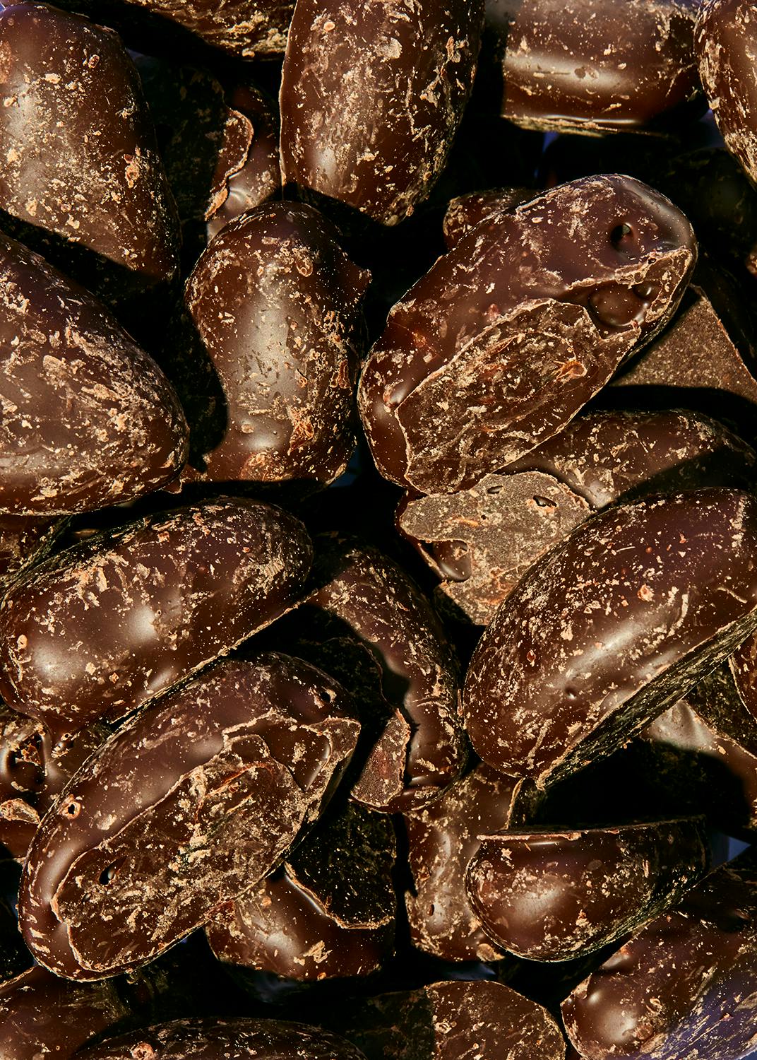 Dates covered in dark chocolate 1kg a close up of a pile of dark chocolate covered nuts