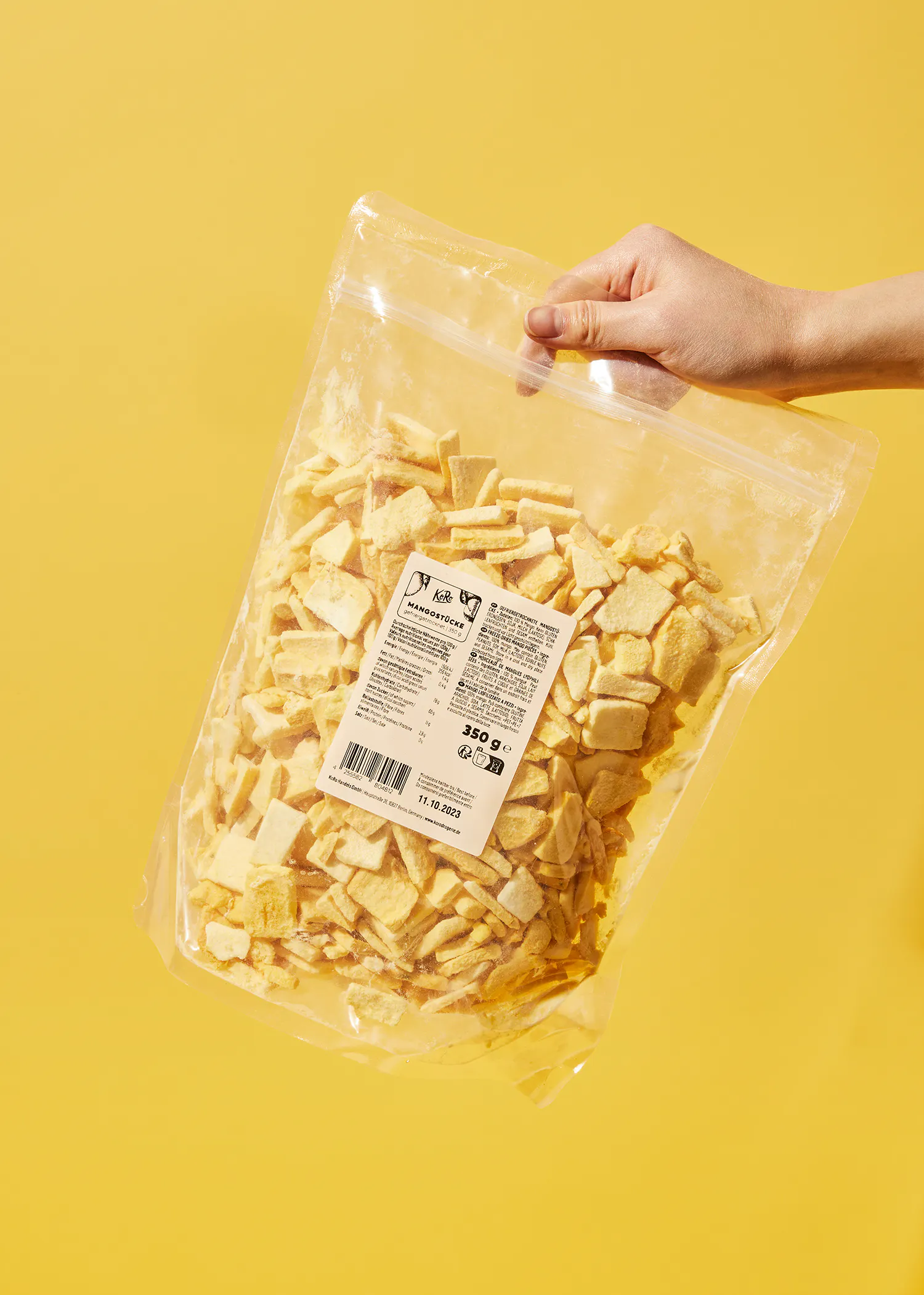 a person is holding a bag of sliced bananas