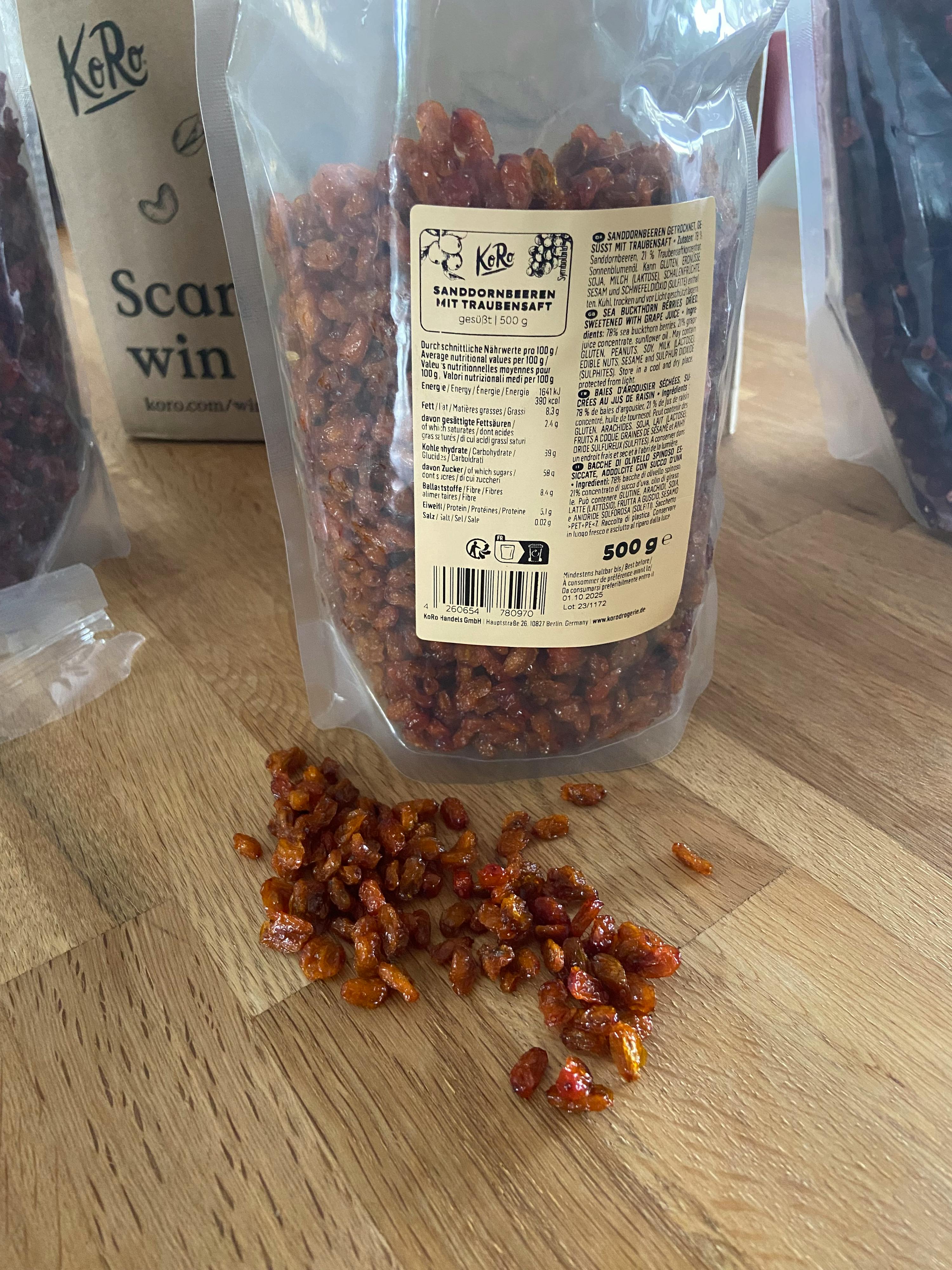 a bag of raisins sits on a wooden table