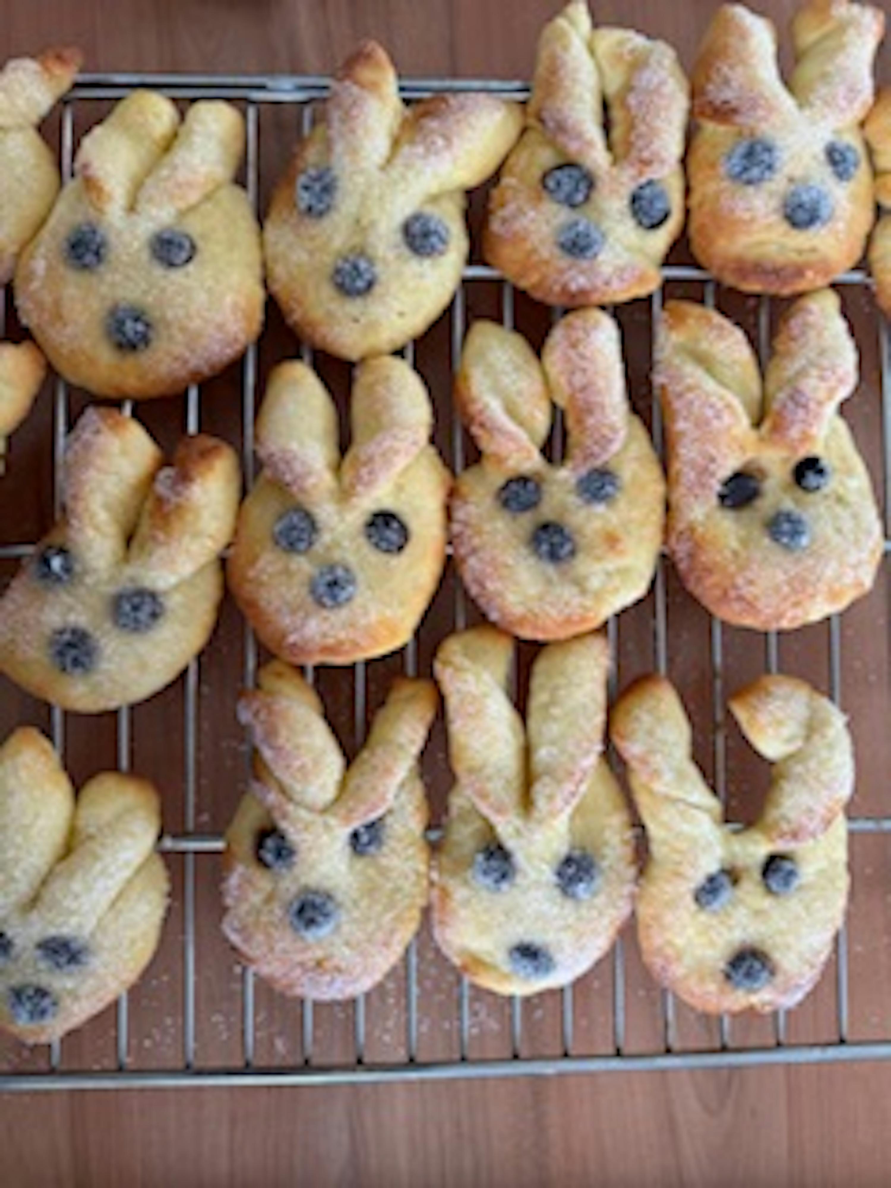 a bunch of bunny shaped cookies are sitting on a cooling rack