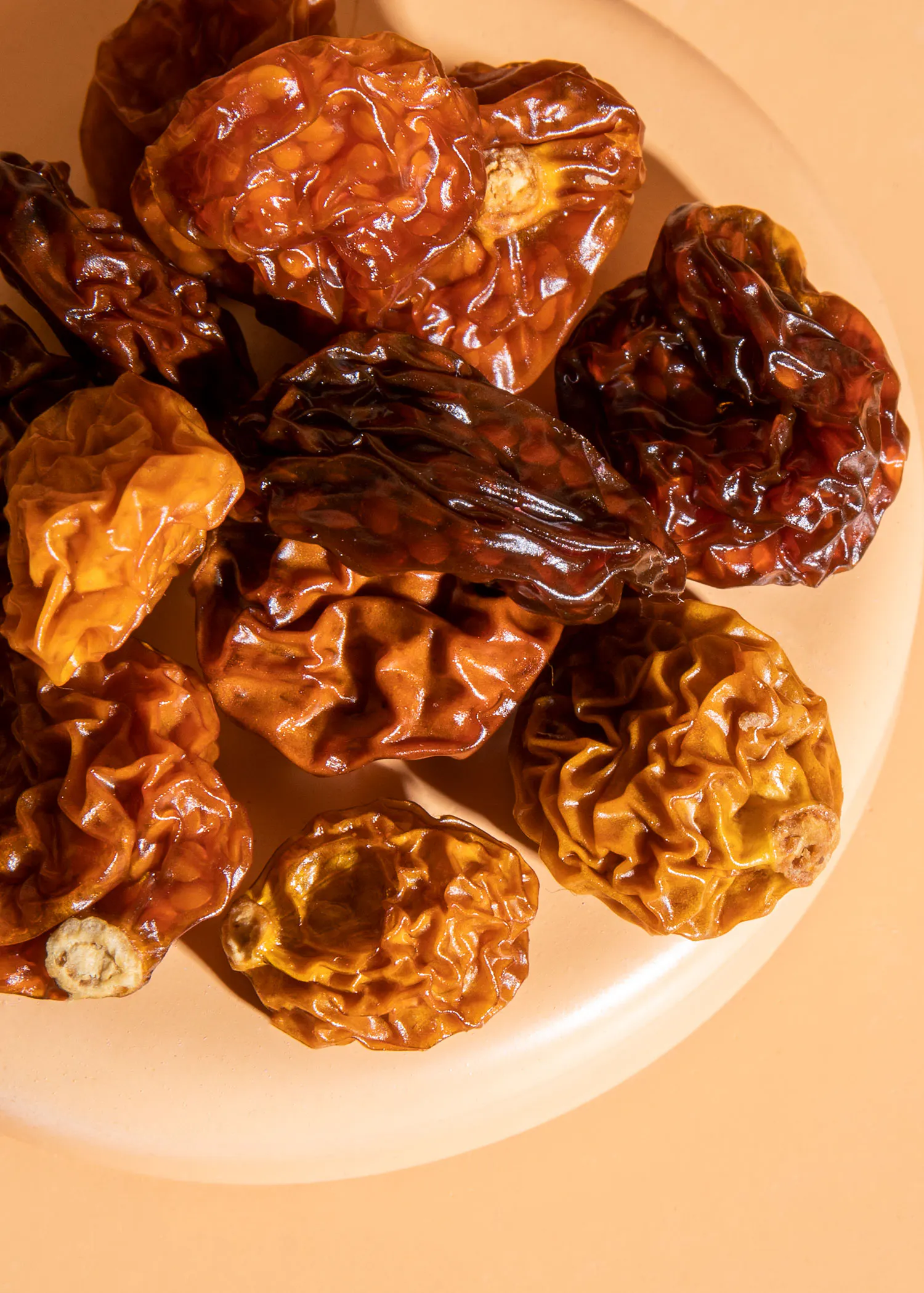 a close up of a plate of dried tomatoes on a table