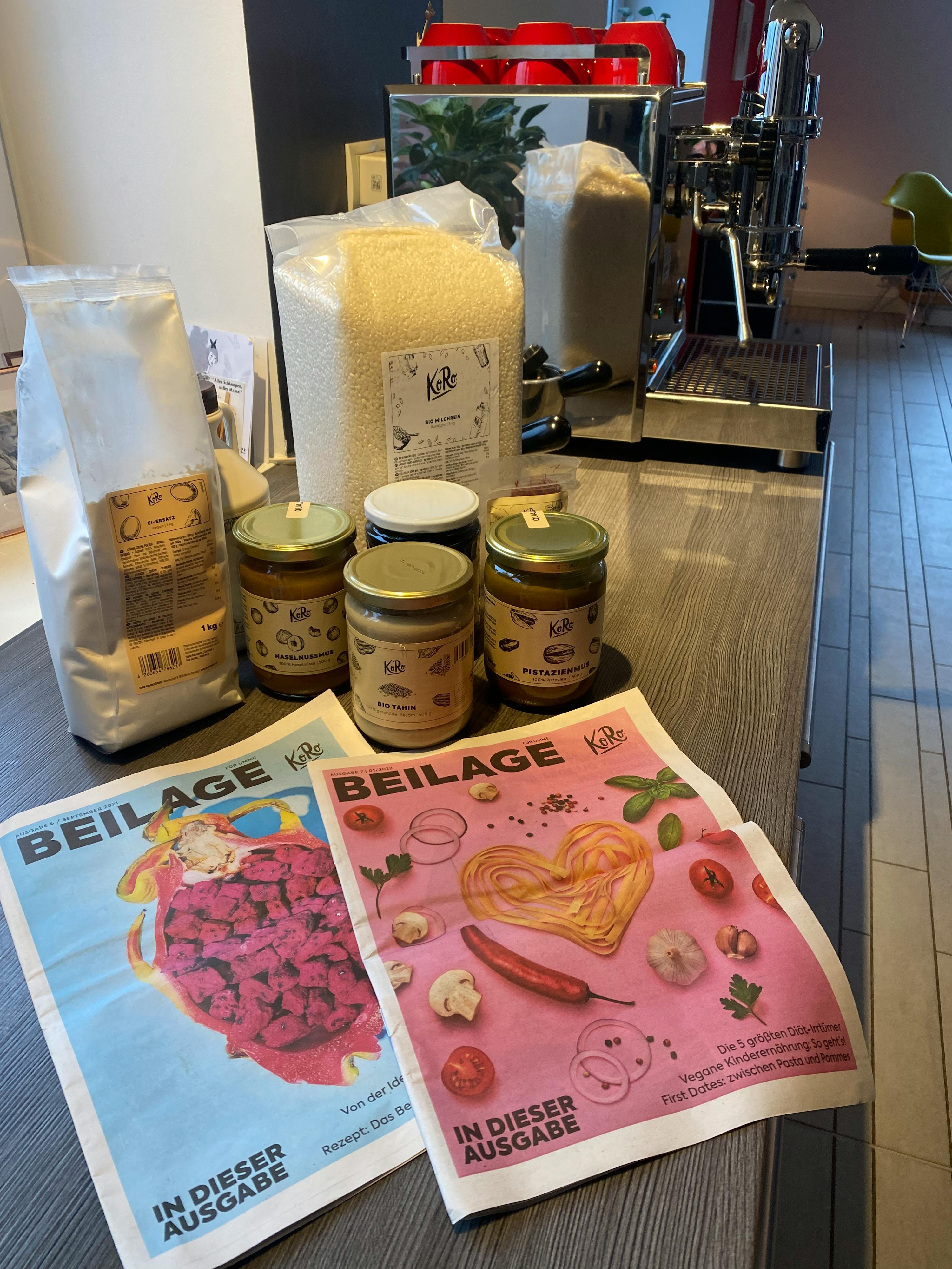 a table with a bunch of food and a newspaper that says beilage