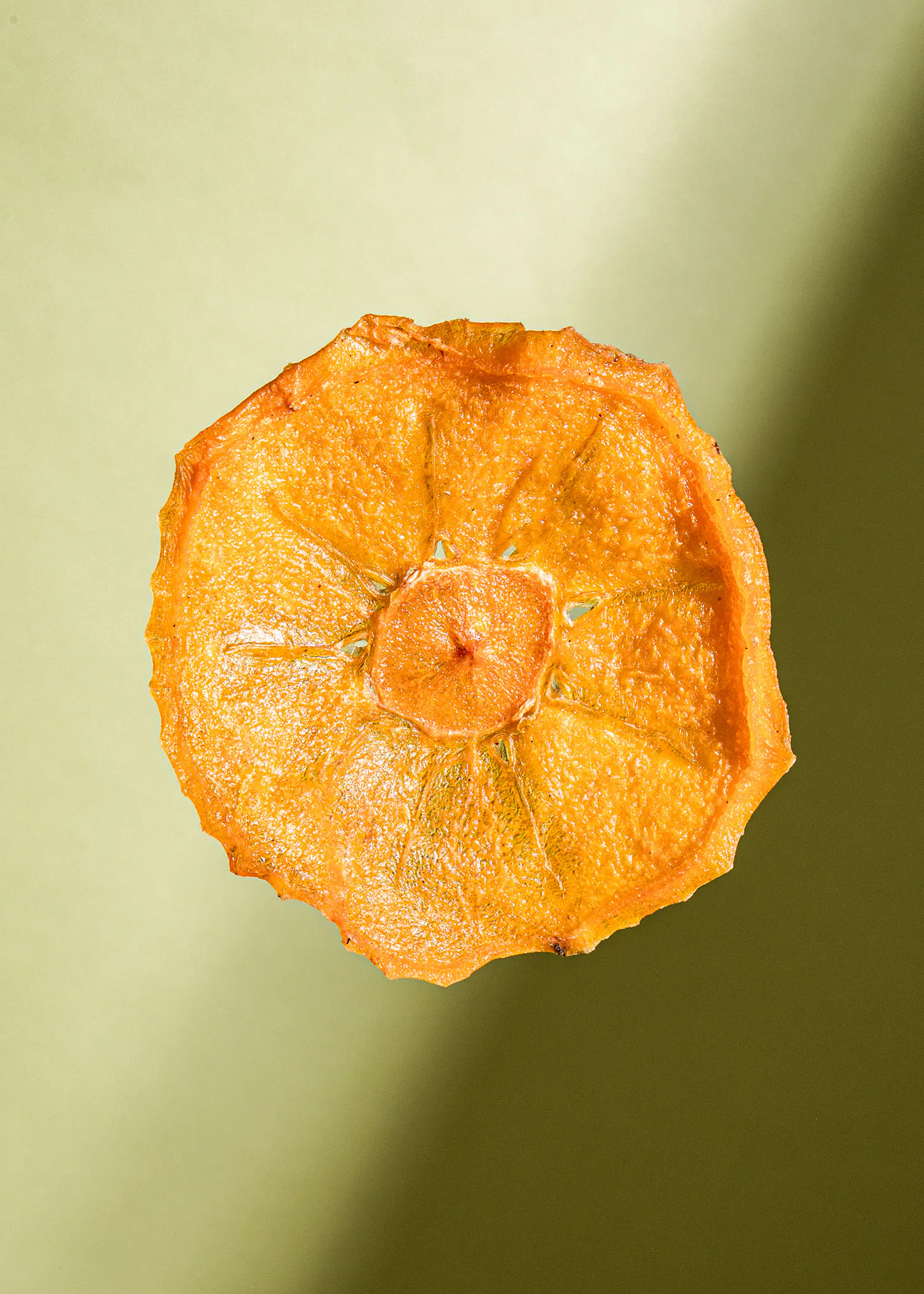 a close up of a sliced orange on a green background