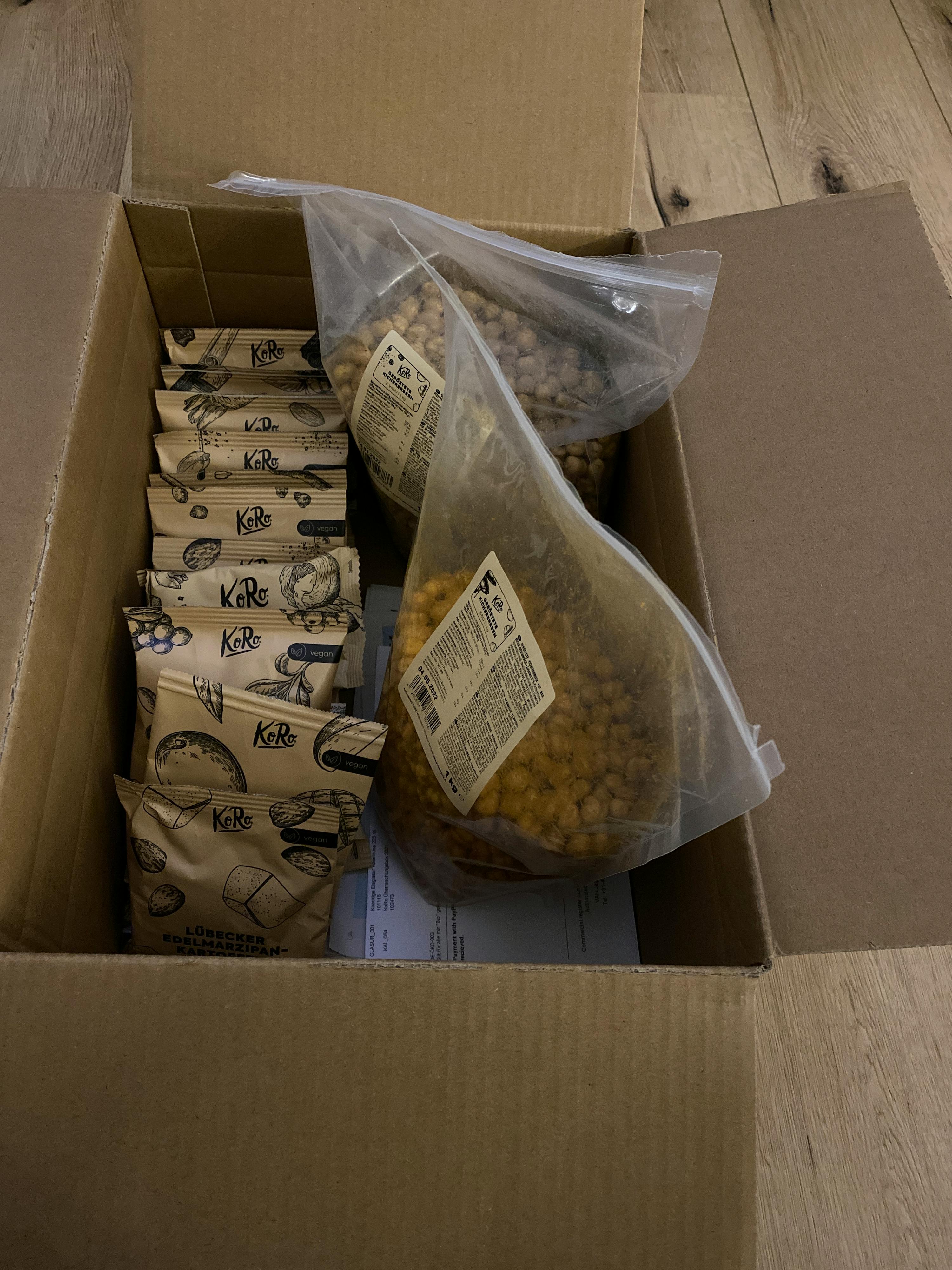 a cardboard box filled with a variety of nuts and snacks