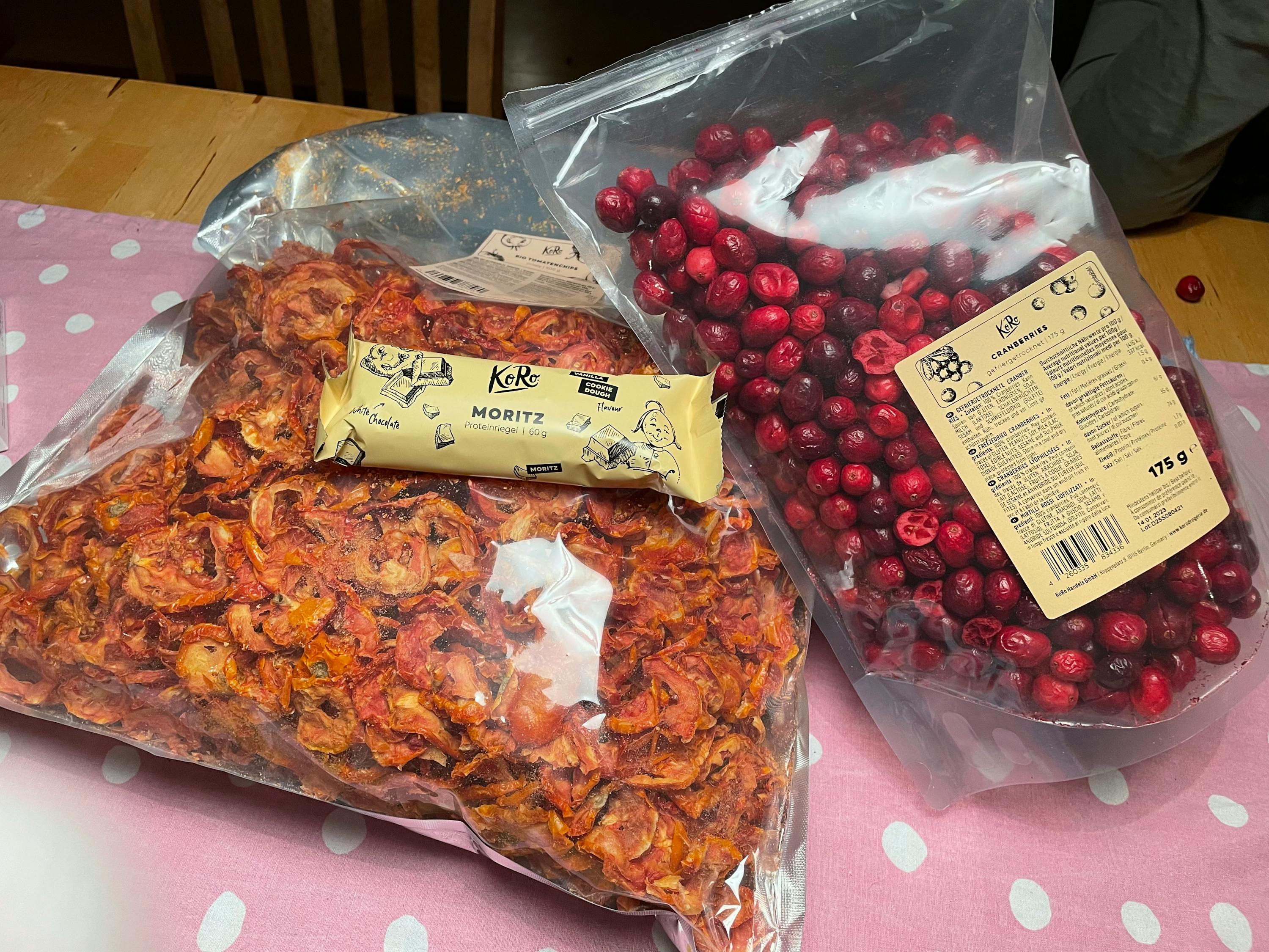 a bag of cranberries next to a bag of moritz