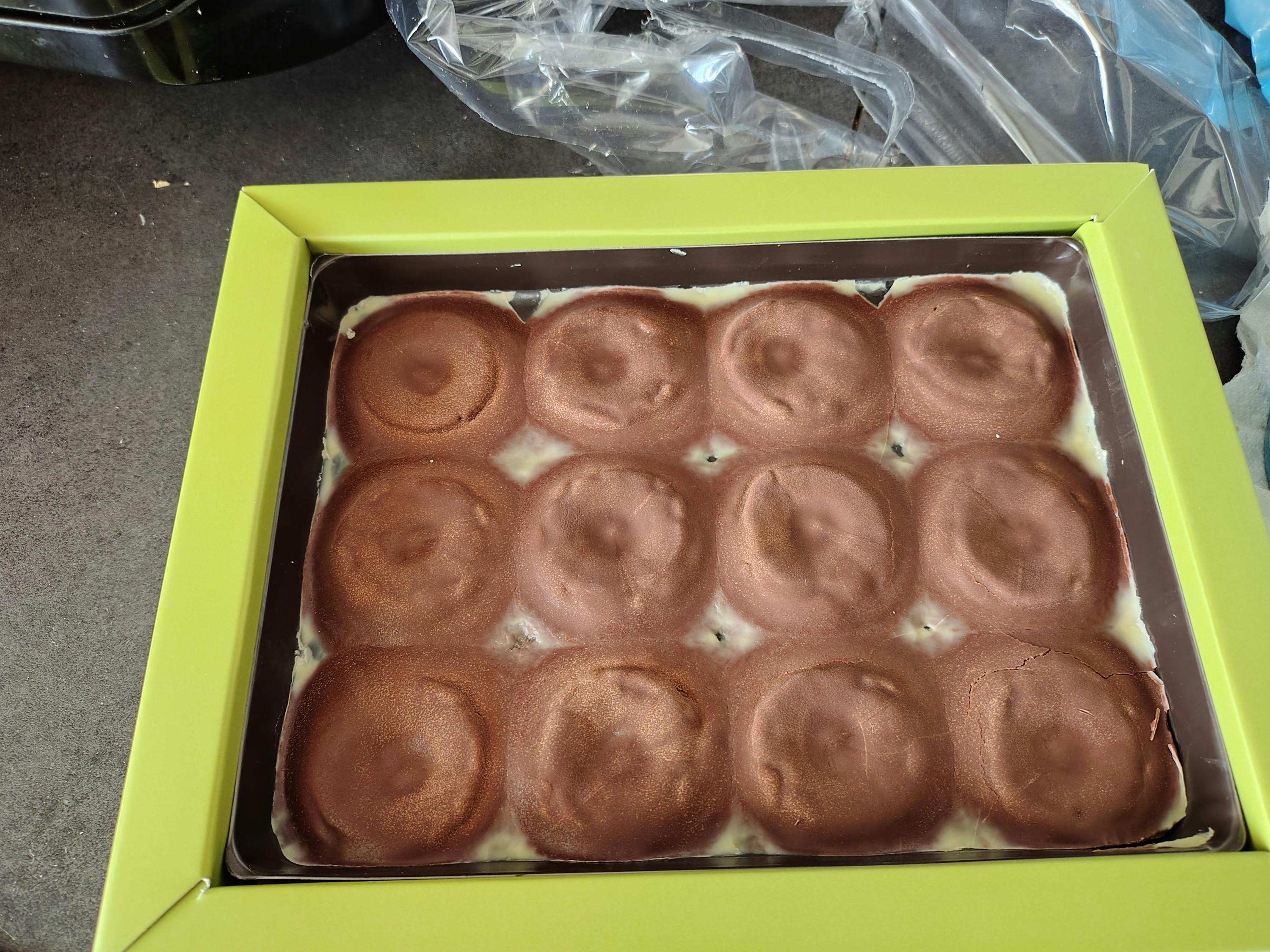 a green box contains a chocolate dessert with circles on it