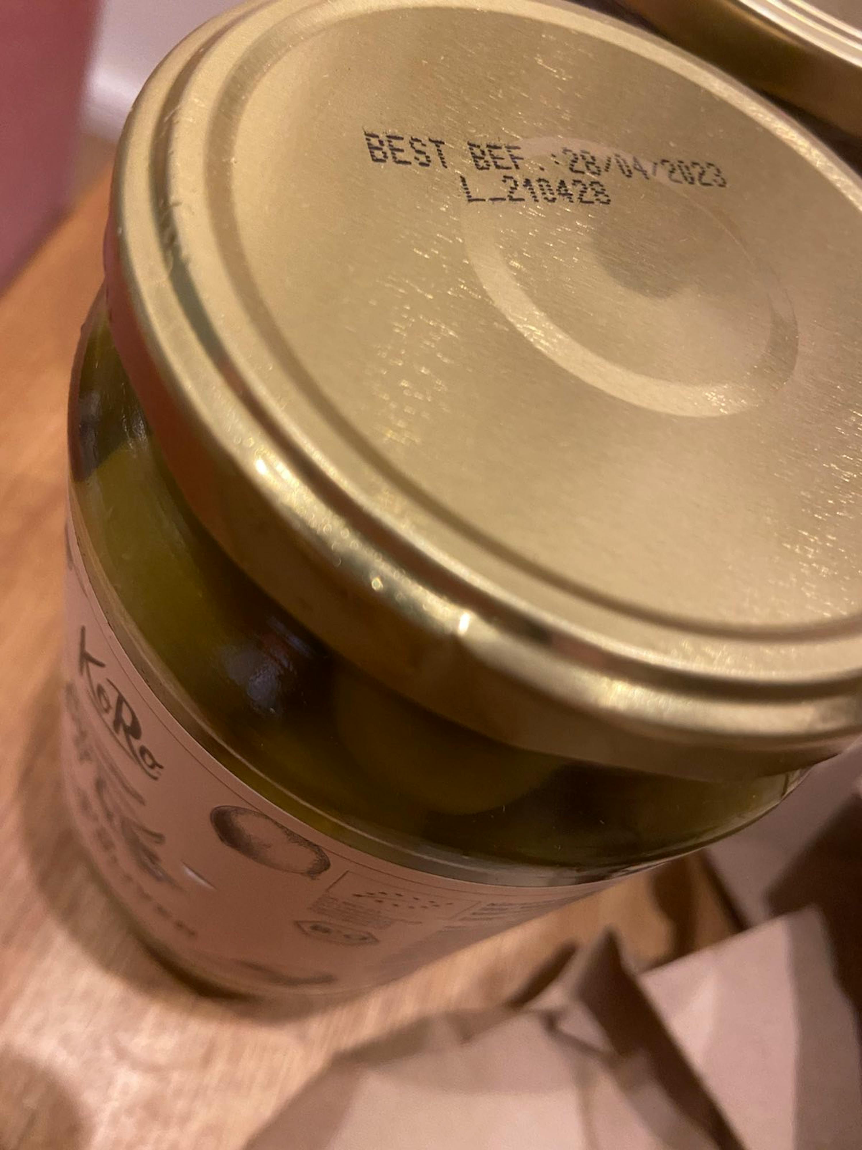 a jar of olives has a best before date stamped on the lid