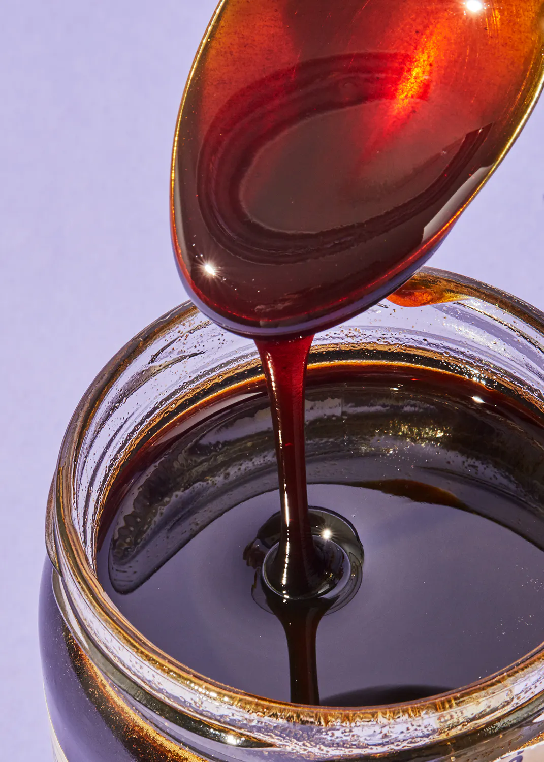 a jar of syrup with a spoon in it