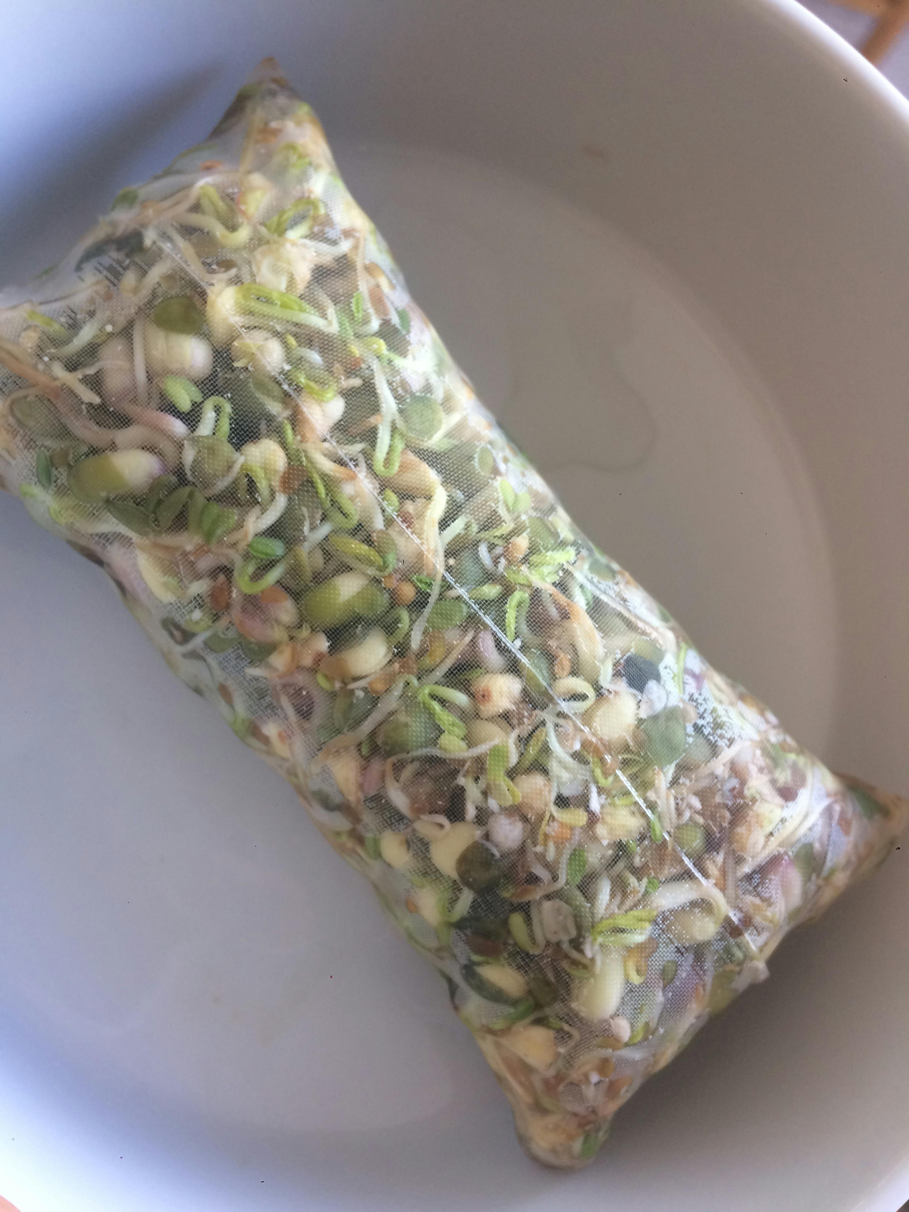 a bag of sprouts sits in a white bowl