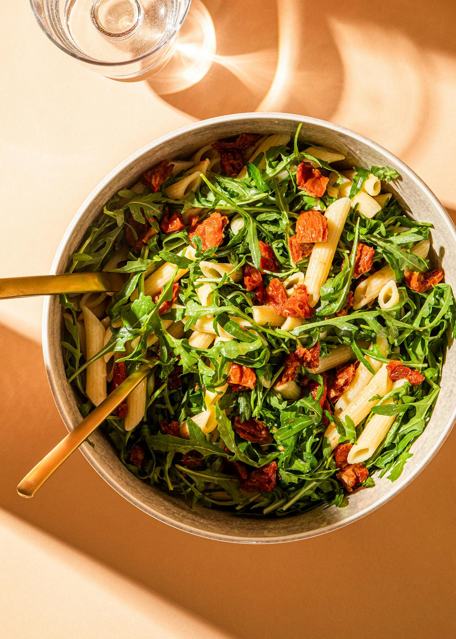 a bowl of pasta salad with a fork in it