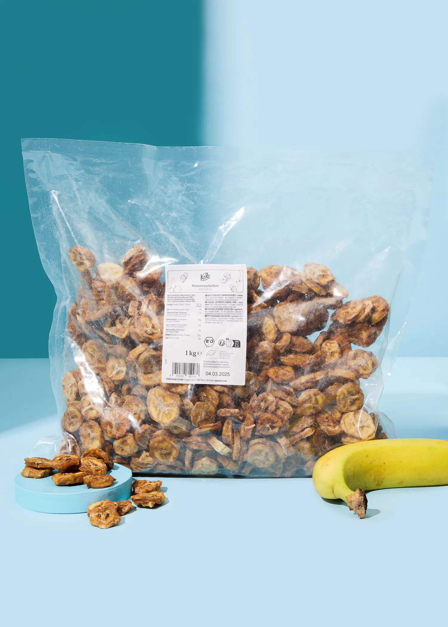 a bag of dried bananas sits next to a banana
