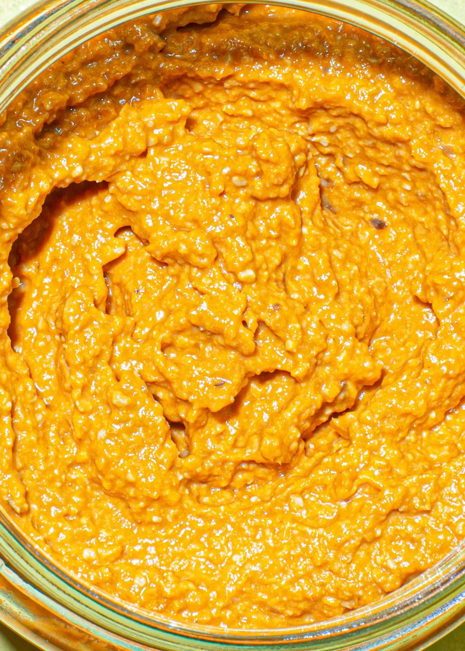 a close up of a jar of orange sauce